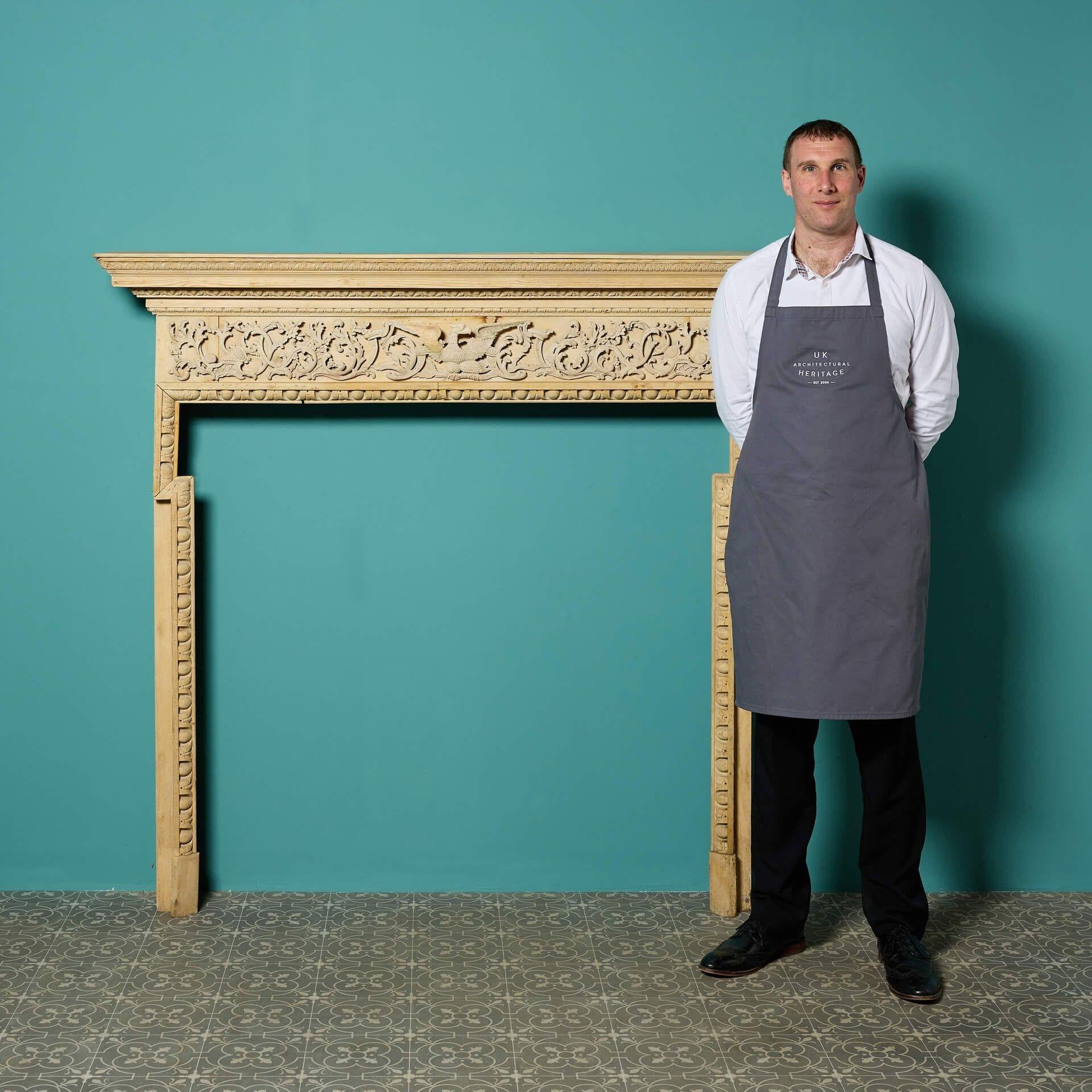 A rare antique George III carved pine fireplace. Dating to the mid 18th century, this fire surround showcases a beautiful ornate frieze carved with scrolling foliage and centred with an eagle.

A truly elegant chimneypiece, not only for Georgian