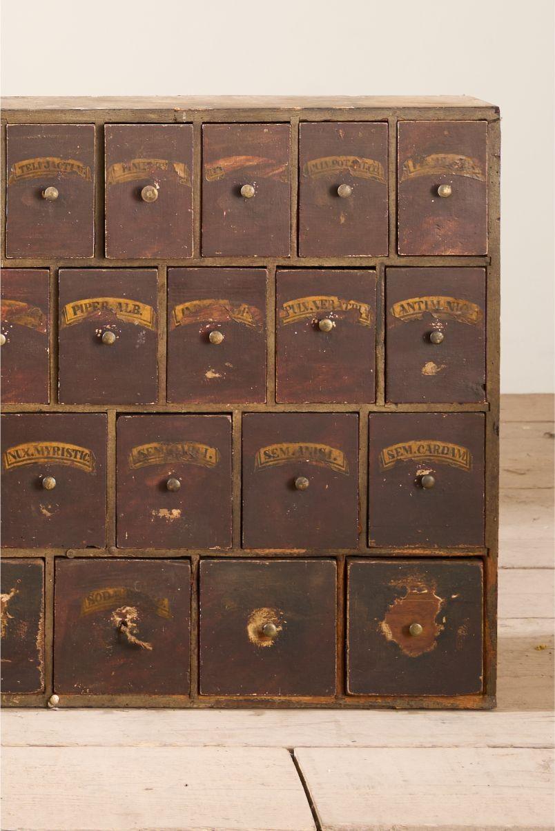 This is a rare surviving piece that we found in an old chemist in Nottingham, England. It dates to the early 19th century and is complete with its original labels. It also has a wonderful patina to the paint which adds to its decorative charm. This