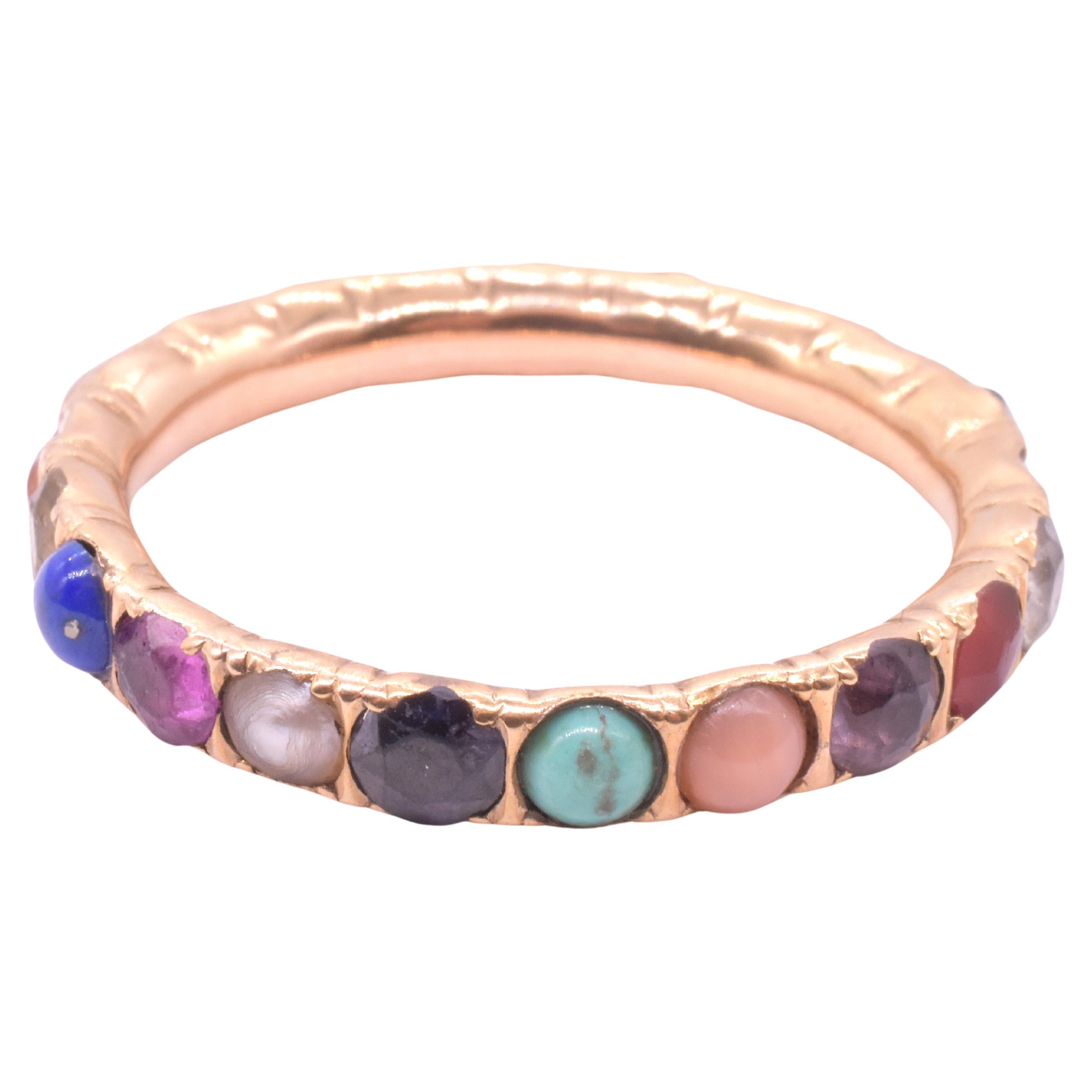 Late Georgian multi stone harlequin eternity band with individually carved stones bordered in gold which form a complete band, a series of circles within a circle. Rarely have we found an eternity band in a large size 13. 

The word 