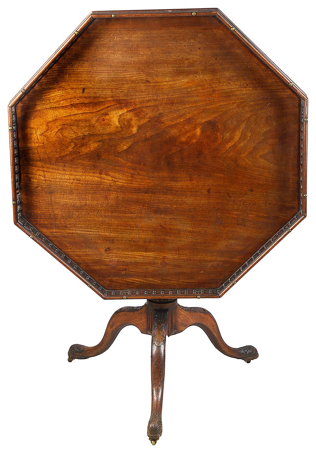 A very good quality Georgian period Mahogany galleried octagonal occasional side table, having a wonderful faded patina, raised on a turned tapering fluted column, ring turnings and a tripod base, each leg having carved foliate decoration,