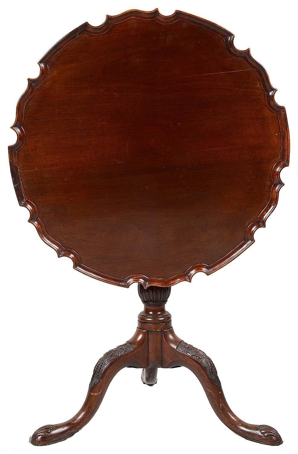 A good quality early 19th century mahogany pie crust table, having a birdcage hinge, turned tapering column and raised on wheat sheaf carved tripod base.