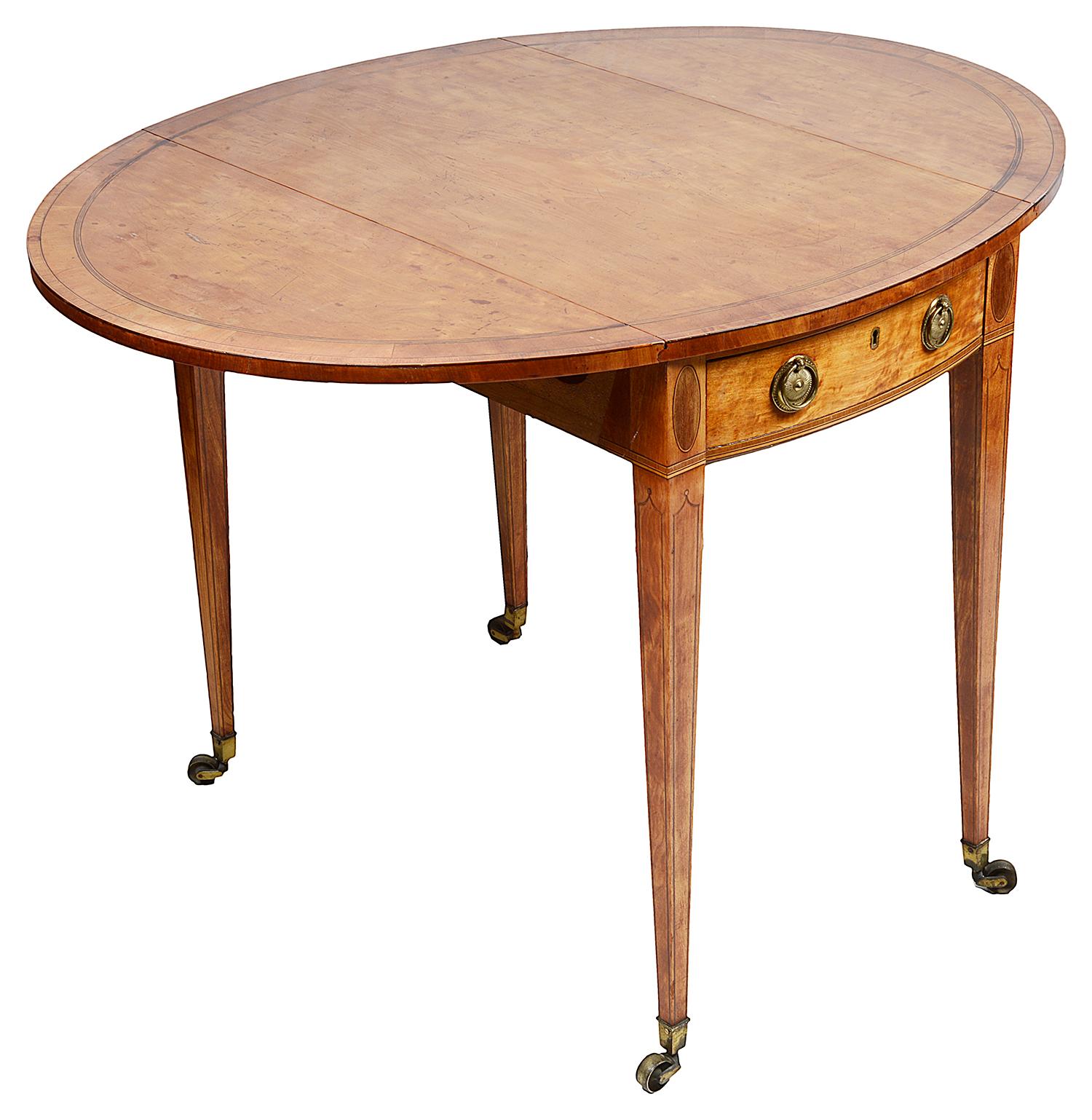 A very good quality 18th century satinwood pembroke table, the across banded top, a single bow fronted drawer, original brass handles, oval inlaid panels above square tapering, ebony string inlaid legs, terminating in the original brass bucket
