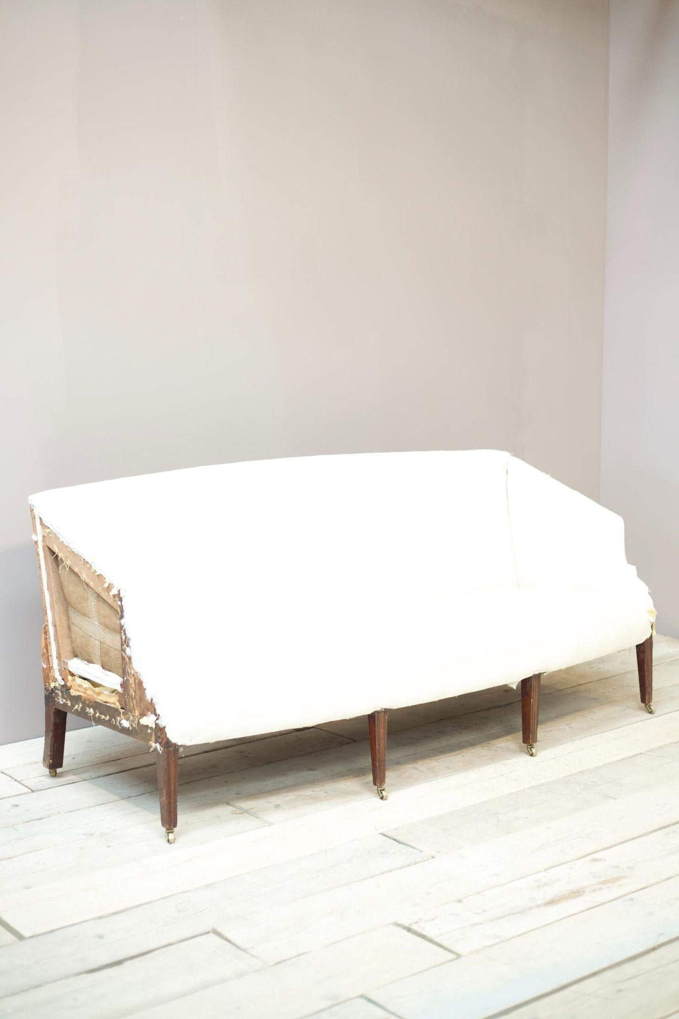 This is a superb quality Georgian period sofa with unusual angled arm design. The curved front stretcher and tall tapered legs give this a very elegant look. Nice proportions as well making this a perfectly useable sofa for everyday use. Various