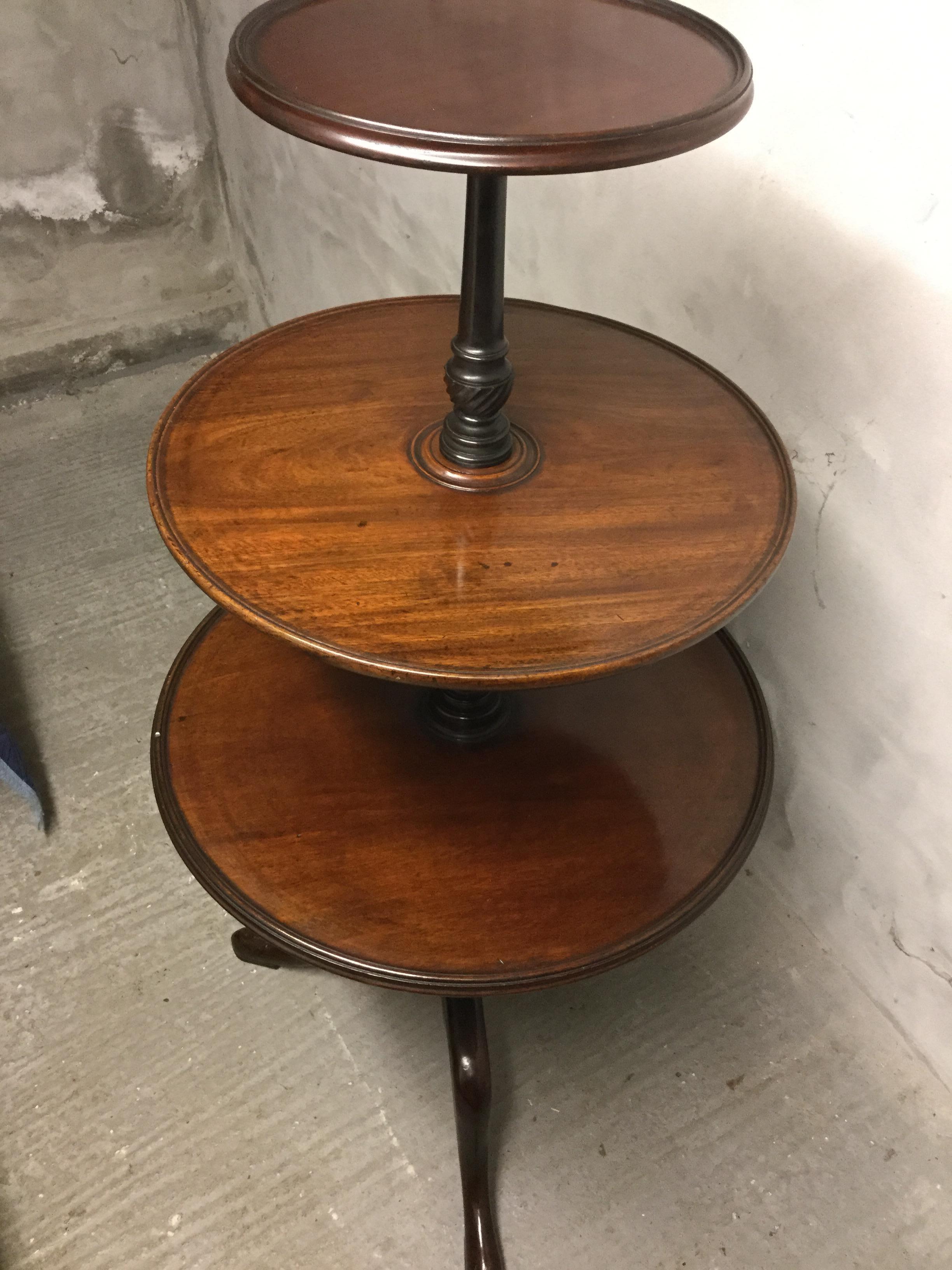 A grand scale three-tier carved mahogany dumbwaiter.