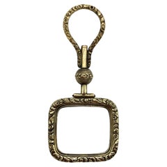 Georgian Pinchbeck Quizzing Glass with Floral Motif and Swivel Handle
