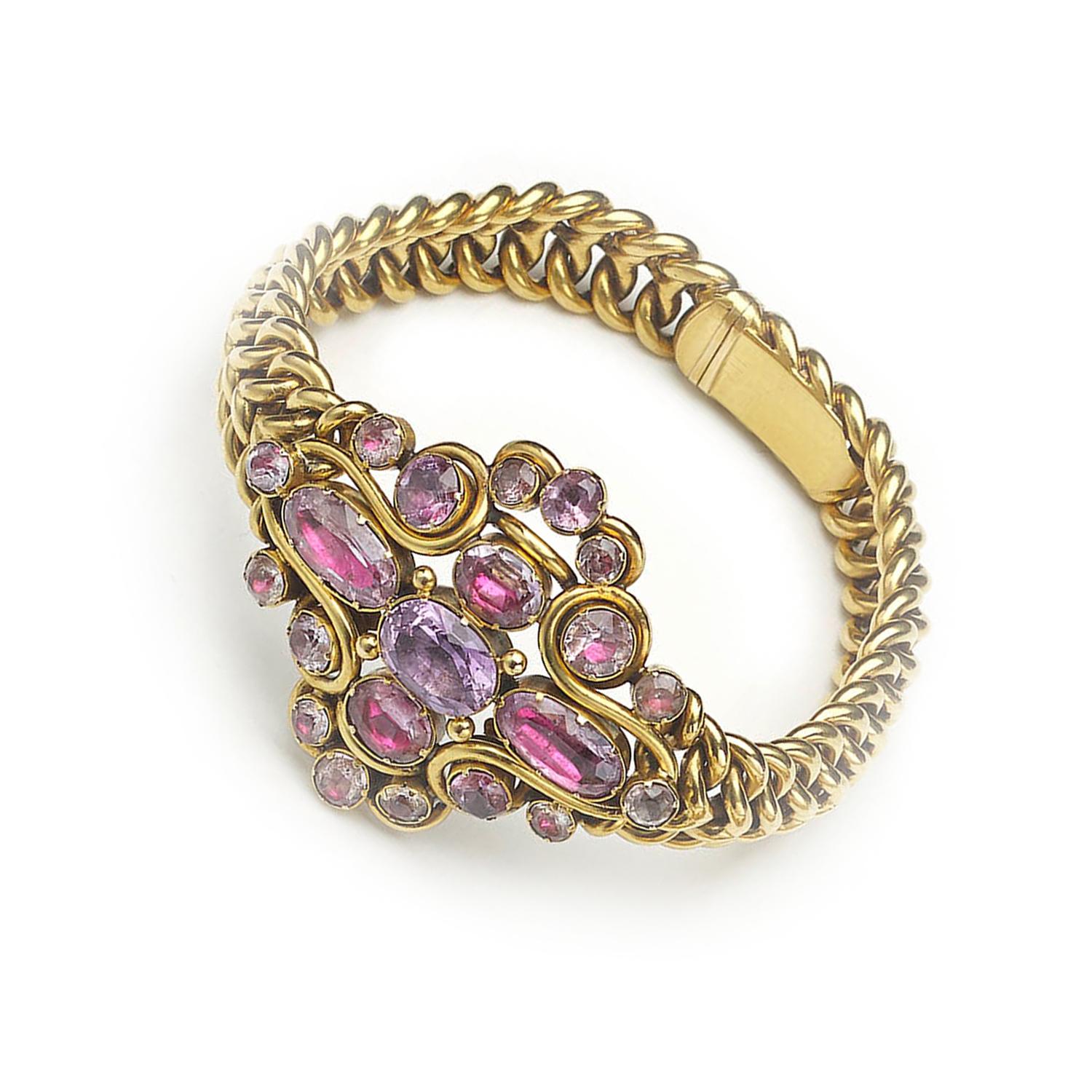 A Georgian pink topaz bracelet, designed as a central cluster of oval-cut and round-cut foil backed pink topaz, in closed back settings, on an integrated heavy woven gold bracelet, with a tongue and box clasp, circa 1835.