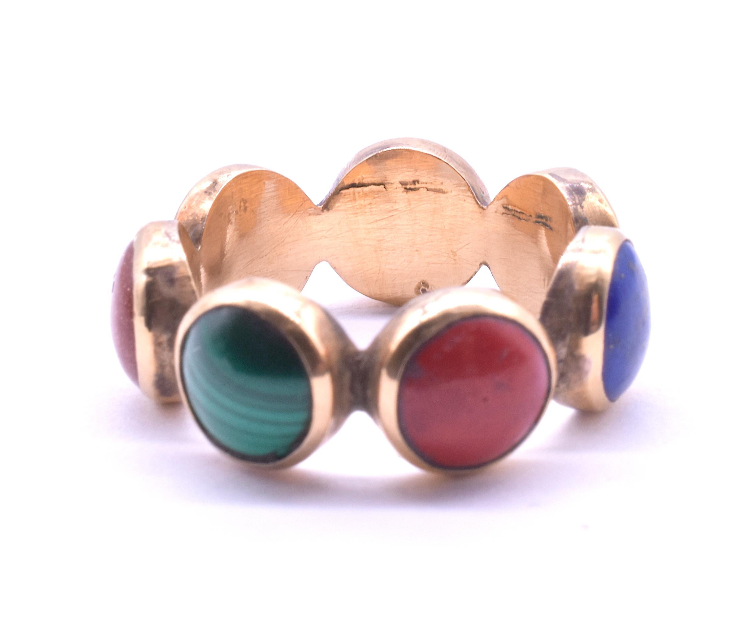 Our rare Georgian planetary ring is made up of seven stones cut and polished en cabochon; 2 lapiz lazuli (blue), 2 goldstone (glass with copper flecks), 2 malachite (green) and a red agate. The stones are set in 18K. The stones represent the