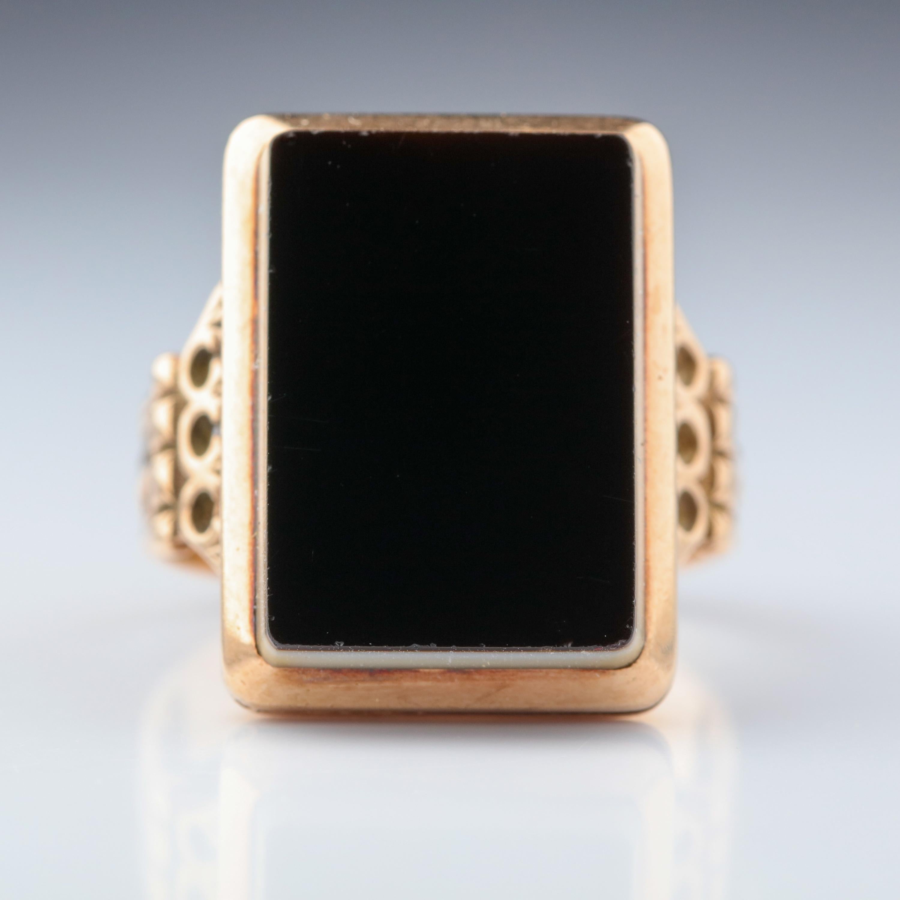 This Georgian-era poison ring from the early 19th century is as cunning as it is beautiful.  The shoulders of the 14k-ish yellow gold ring feature a pair of grand Corinthian pilasters that support a tablet of natural onyx that is white on the bottom