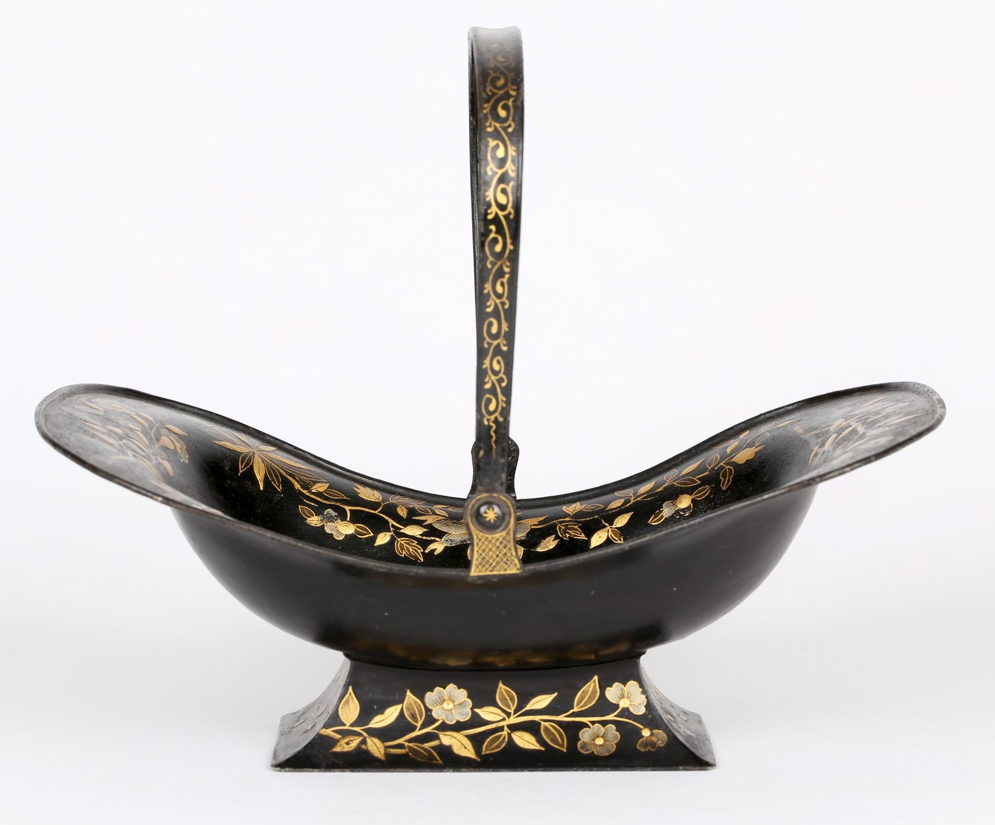 A very fine quality large Georgian toleware black japanned bread basket with floral and a bird design probably Pontypool, Wales and dating from around 1820. The basket stands raised on a rectangular shaped foot, the curved rectangular shaped basket