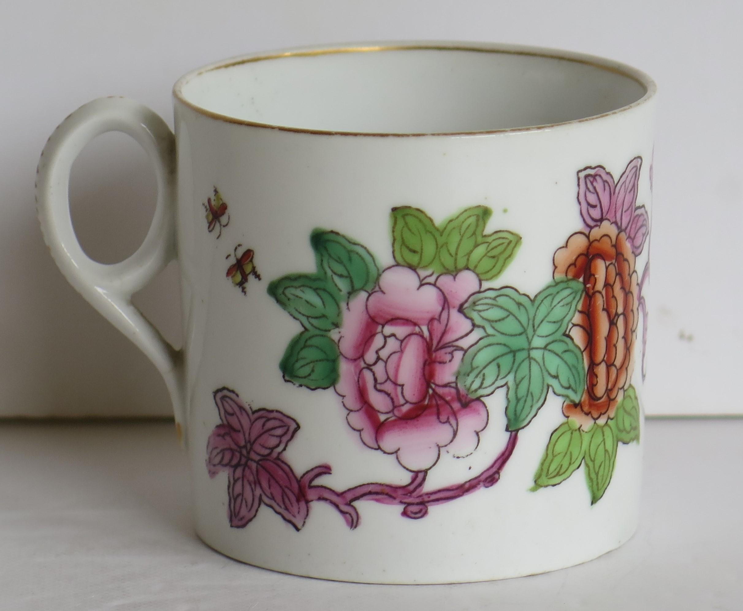 This is a good hand-painted English coffee can, from the late George-III period, of the early 19th century, circa 1815, which we attribute to New Hall.

This coffee can is nominally straight sided with an oval ring handle and pointed lower