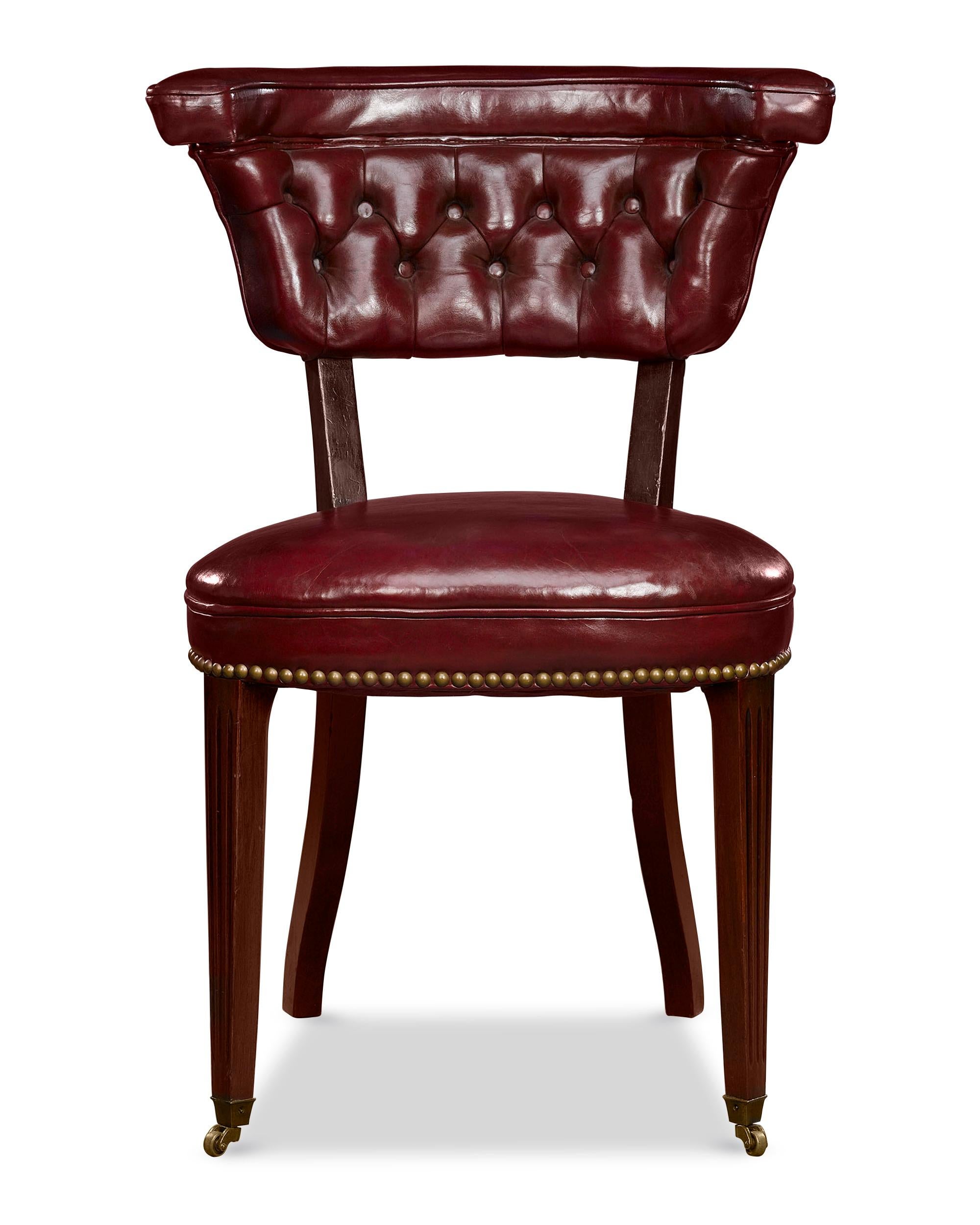 A handsome and rare Georgian-style reading chair, expertly crafted of mahogany. With its high, wide back that slims at the seat, the chair is constructed so that the reader sits in the chair backwards, comfortably resting their arms on the yoke.
