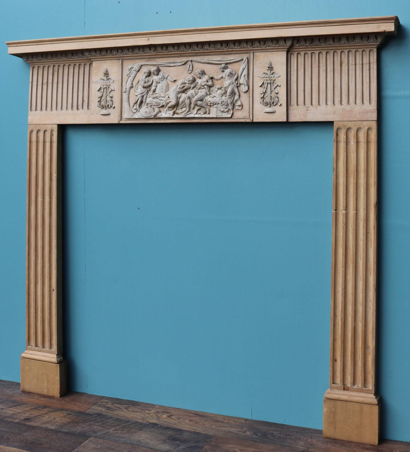 An antique neoclassical style fire surround constructed from pine, with applied gesso (composition) decoration.

Additional Dimensions
Opening height 103 cm
Opening width 104.5 cm
Width between outside of foot blocks 135 cm.