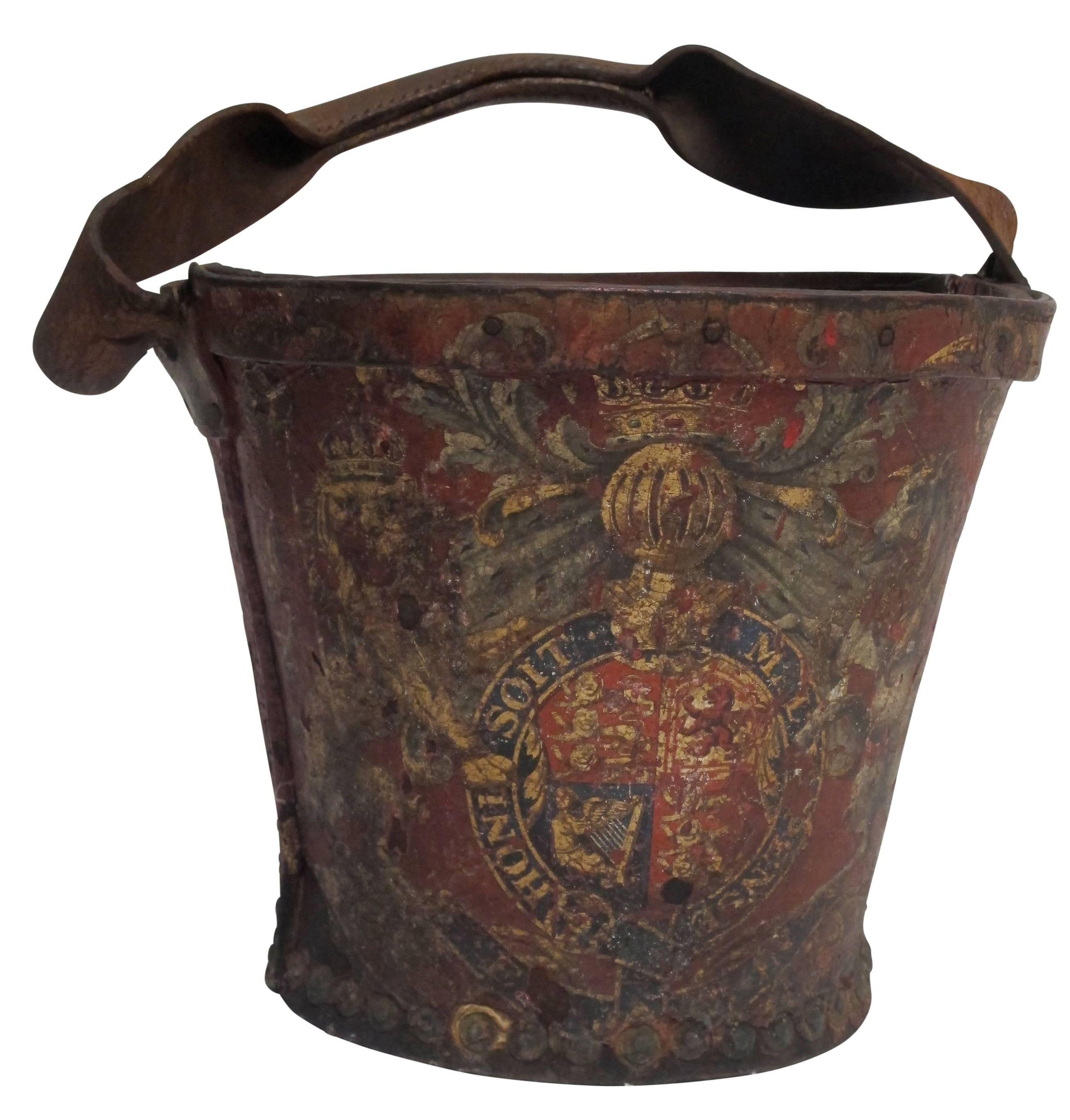 Antique red leather fire bucket with elaborate hand-painted British insignia, body having a circular tapered form, England, early 19th century.
