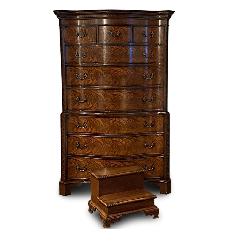 A superb-quality Georgian revival serpentine-front chest on chest, the drawers with highly figured flame mahogany and with blind fretwork to the canted corners, the whole standing on bracket feet. Highly-detailed original brass pulls. Includes a