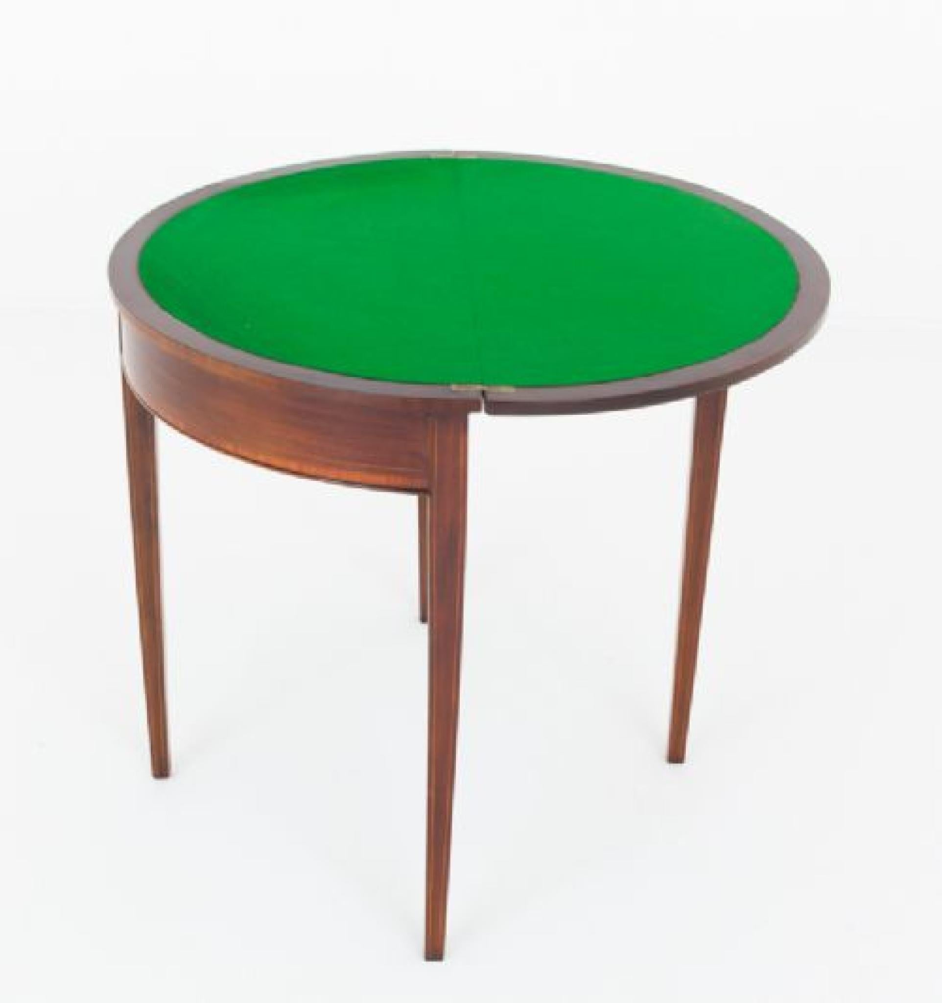 Georgian Revival mahogany card table
This demi lune card table is of a Georgian design.
The table is raised upon tapered legs.
Circa 1900
The whole of the table featuring satinwood crossbanding and ebonised and boxwood inlaid lines.
The top opens to