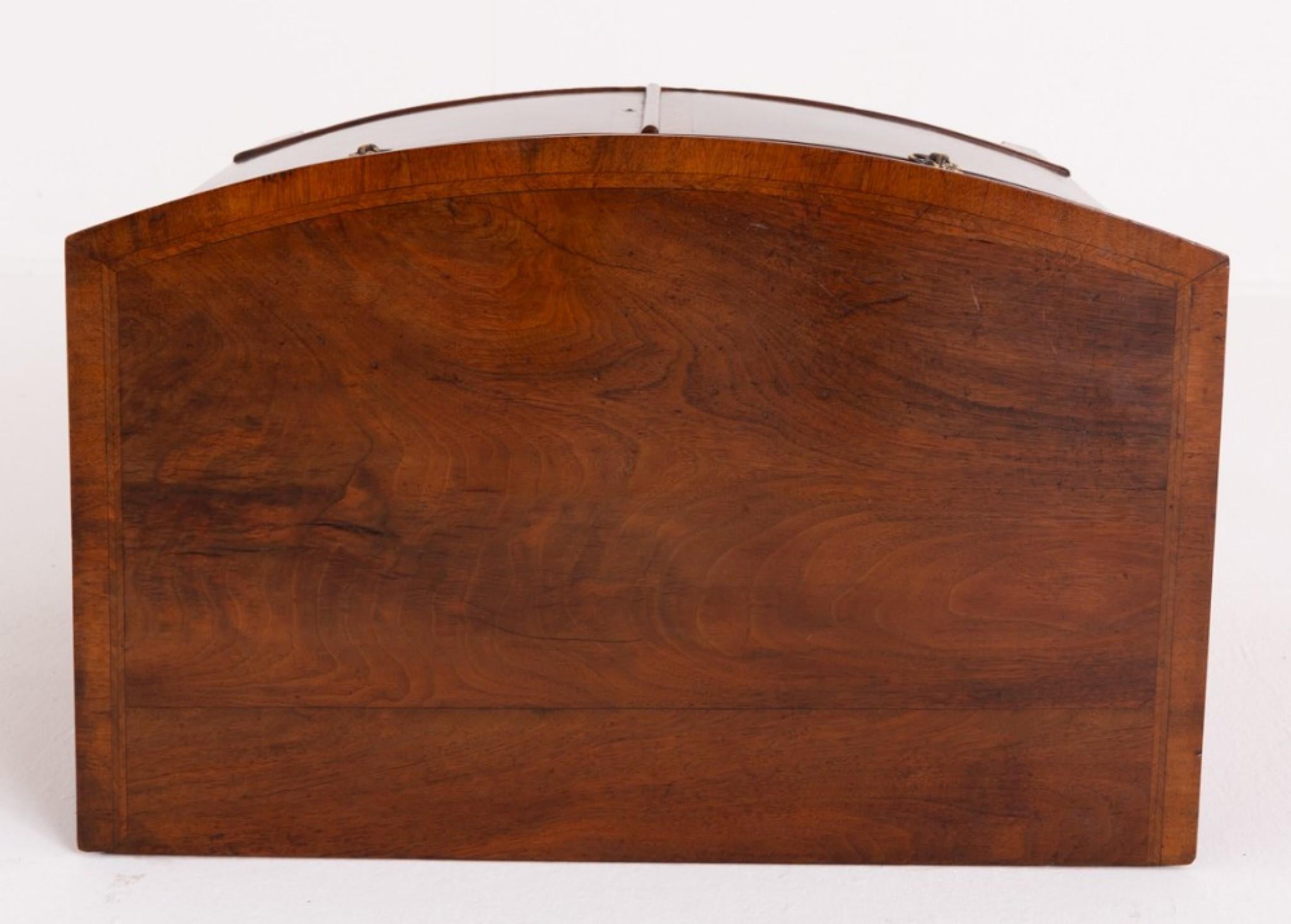 Walnut Georgian Revival bow fronted side cabinet.
This cabinet stands upon bracket feet.
Circa 1860 Featuring 2 lower doors which feature crossbanding. The 2 upper oak lined drawers having lions head ring pull handles.
The top of the cabinet having