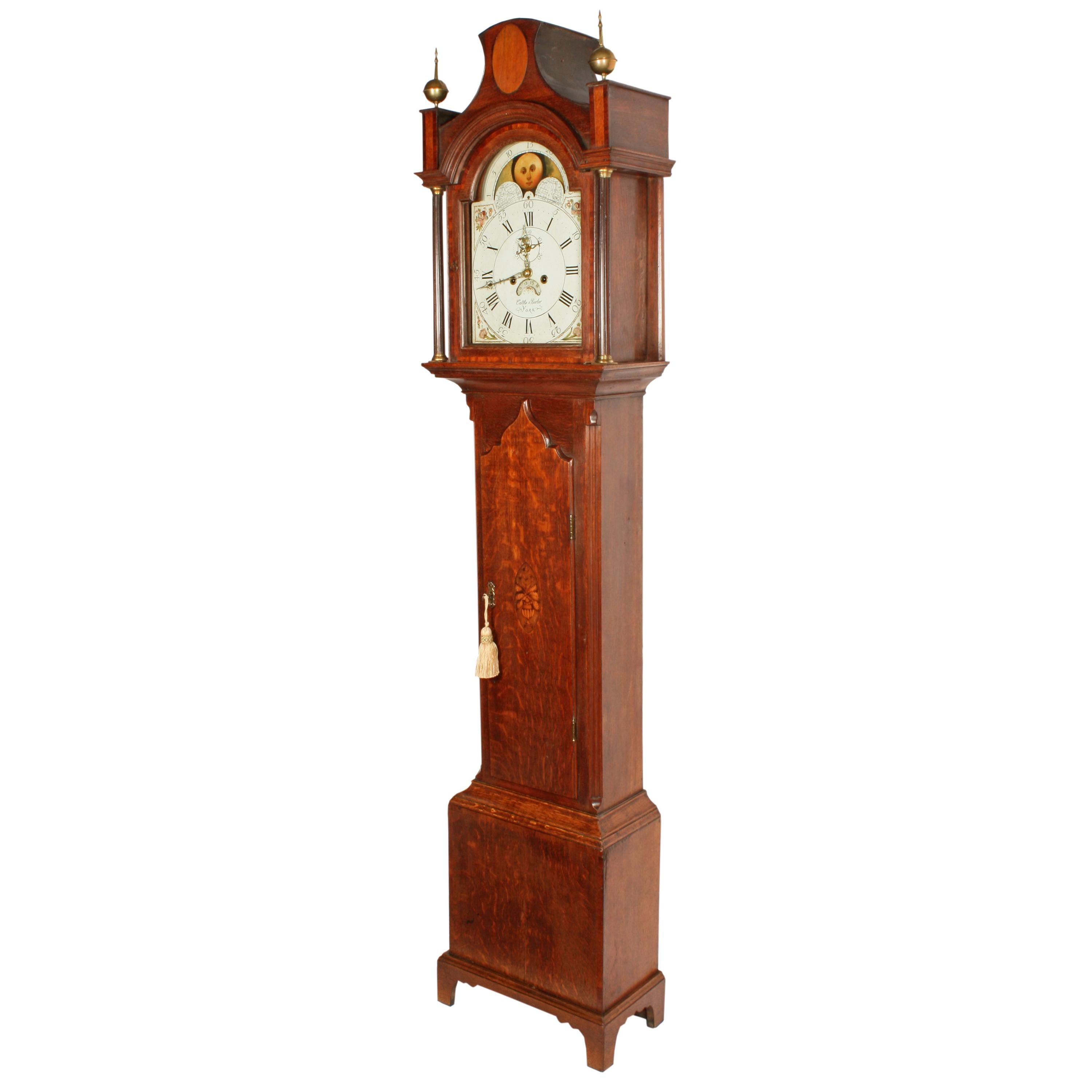 A late 18th-early 19th century oak cased rolling moon grandfather clock.

The clock has a rolling moon painted dial with an eight day movement with an hour strike and a secondary dial.

At the top of the dial is the lunar calendar rolling moon