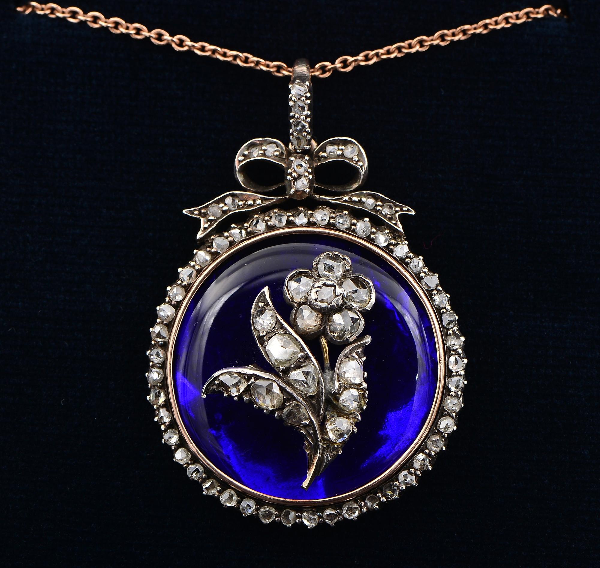 Past Treasure
This surprisingly beautiful antique pendant is Georgian period, 1790 ca
The large circular body is set with a rich Royal Cobalt Blue Bristol glass, encircled in gold within a border of rose cut Diamonds, surmounted by a lovely bow