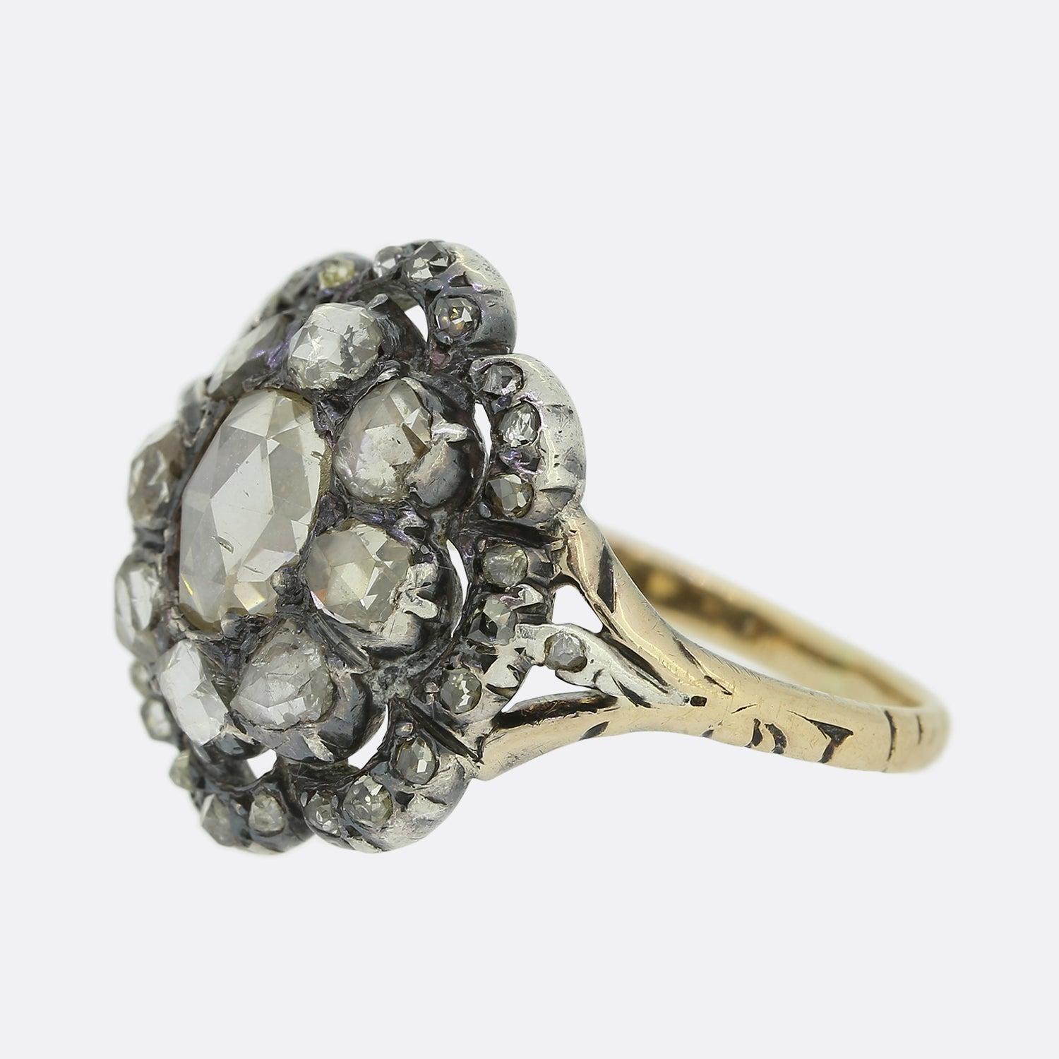 Here we have a wonderful example of Georgian craftsmanship. This multi-layered cluster ring features an oval shaped rose cut diamond at the centre which is circulated by a slightly smaller array of matching rose cut diamonds. Multiple convex motifs