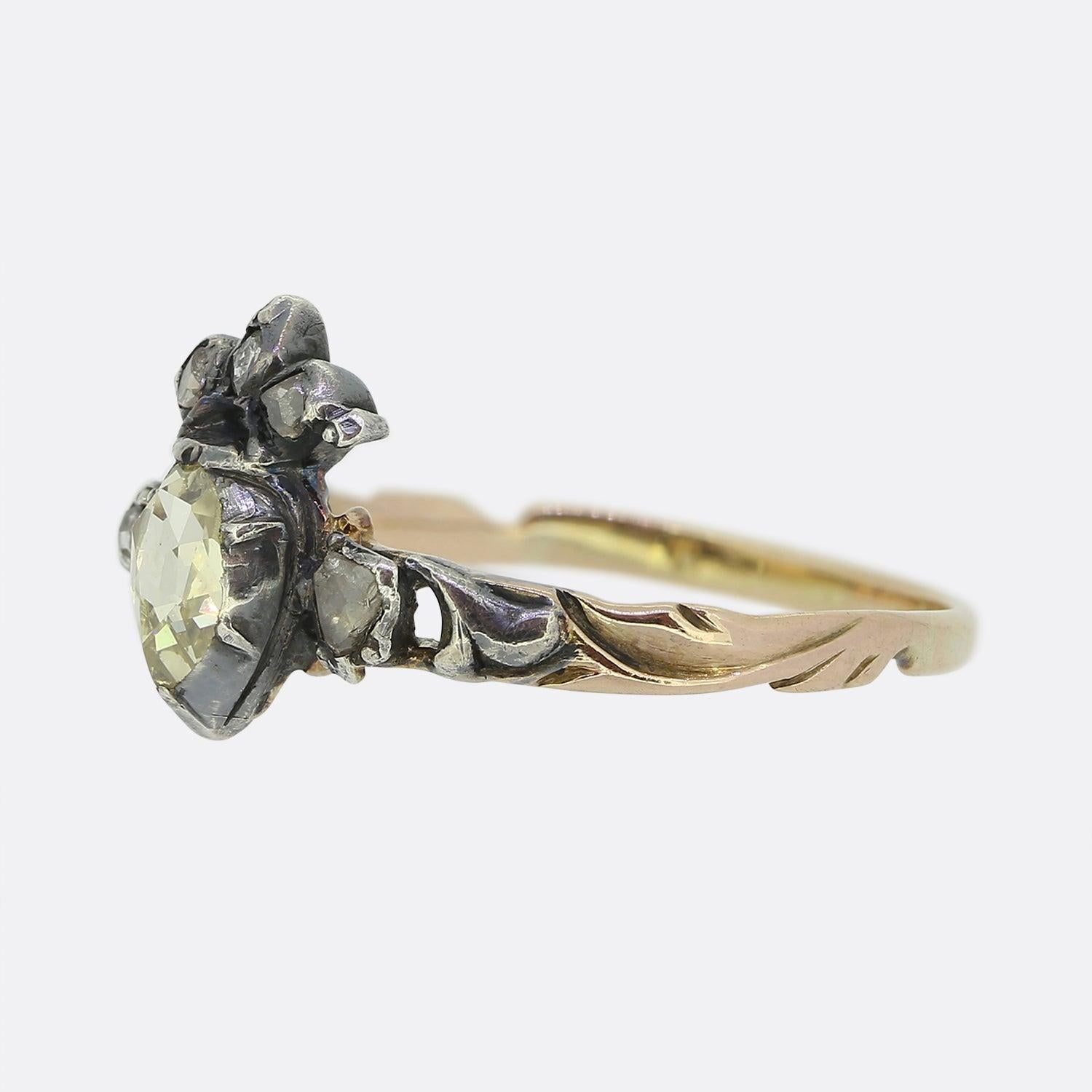 Here we have a delightful antique diamond ring dating back to the Georgian period. A single oval shaped yellow tinted rose cut diamond has been cut-collet set at the centre and surmounted with a rose cut diamond set crown. This focal motif is then