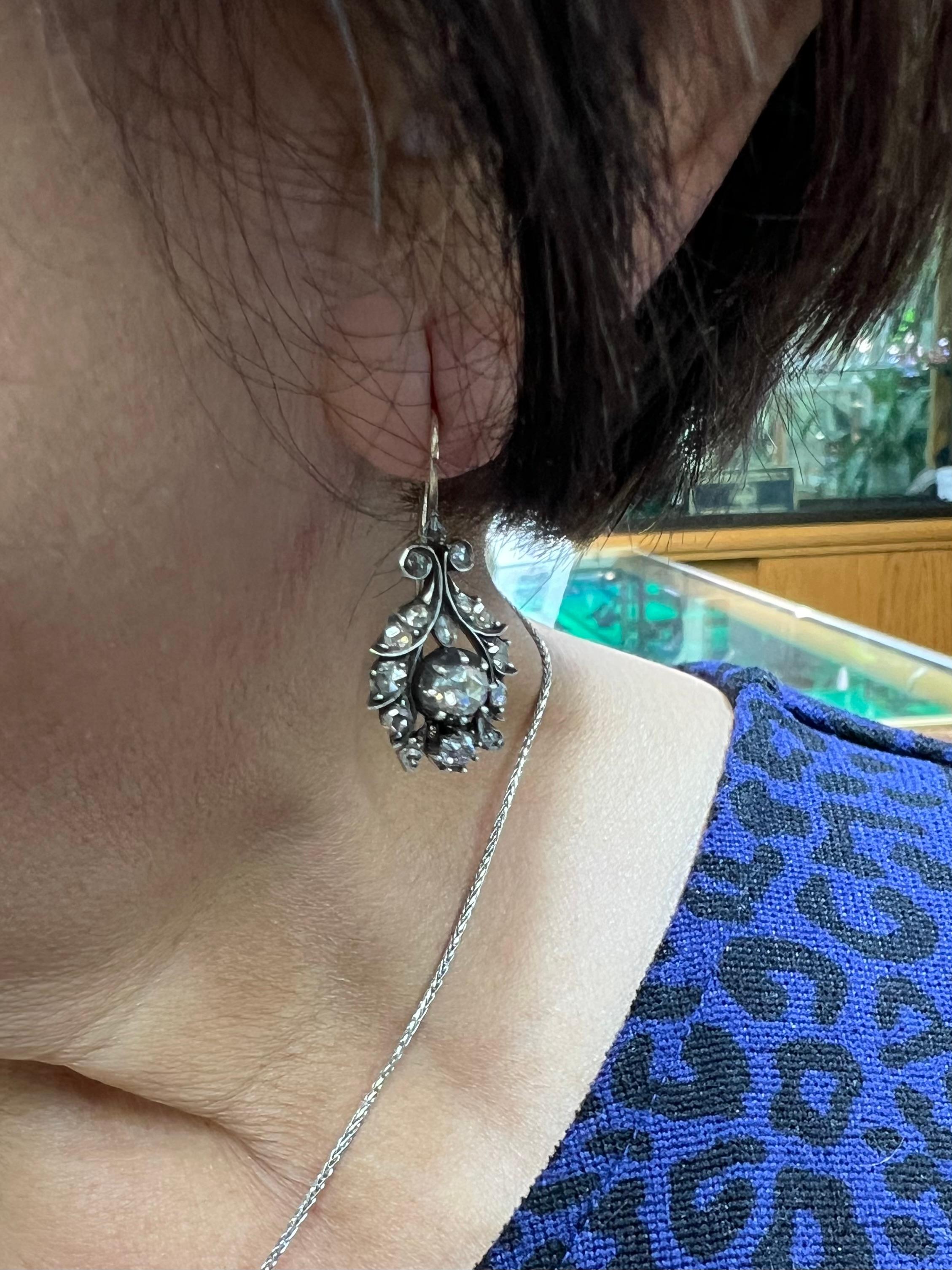 Georgian rose-cut diamond silver and gold drop earrings, circa 1810.

Georgian rose cut diamond drop earrings, like these, dating back to circa 1810, represent a significant intersection of art, culture, and craftsmanship during the Georgian era.