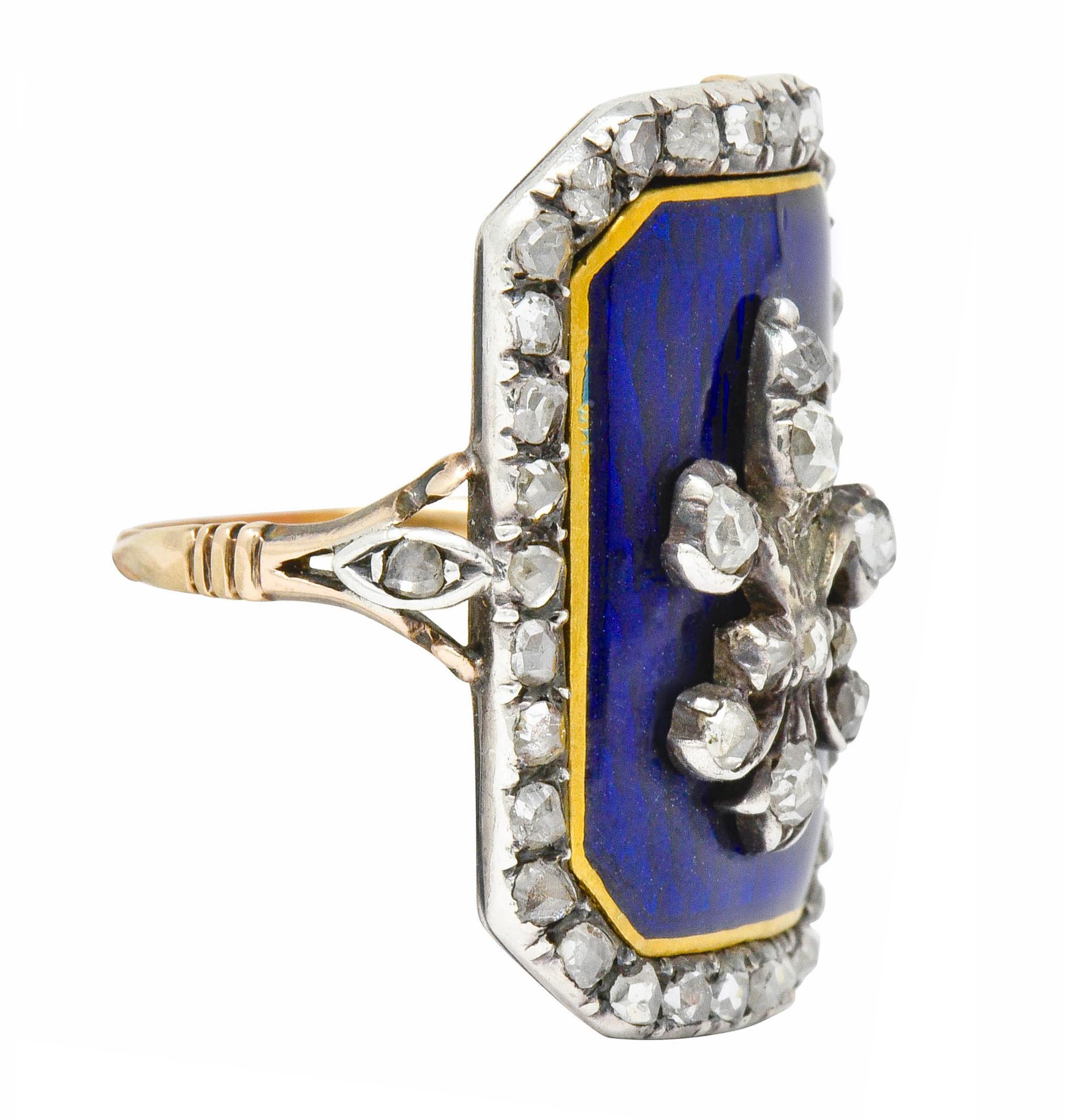 Statement ring designed as a rectangular mounting with a slight bow for a comfortable fit,

Centering a fleur-de-lis emblem with a bright royal blue enamel background with a gold enamel border; exhibiting no loss

Set throughout by rose cut diamonds