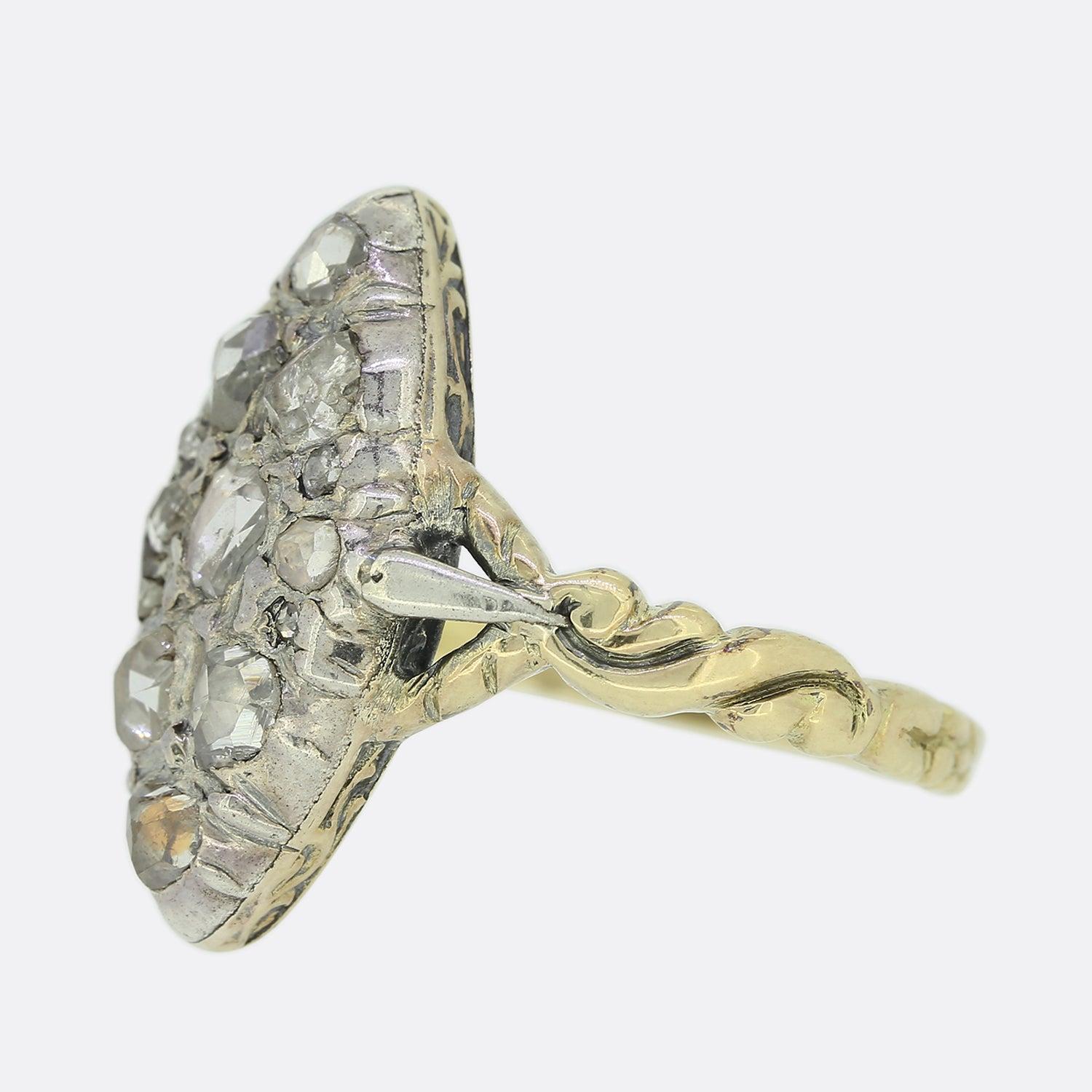 This is an antique diamond navette ring dating back to the Georgian era. It features an array of closely individually tension set rose cut diamonds of differing shapes and sizes; all of which are mounted in silver within a closed back setting whilst