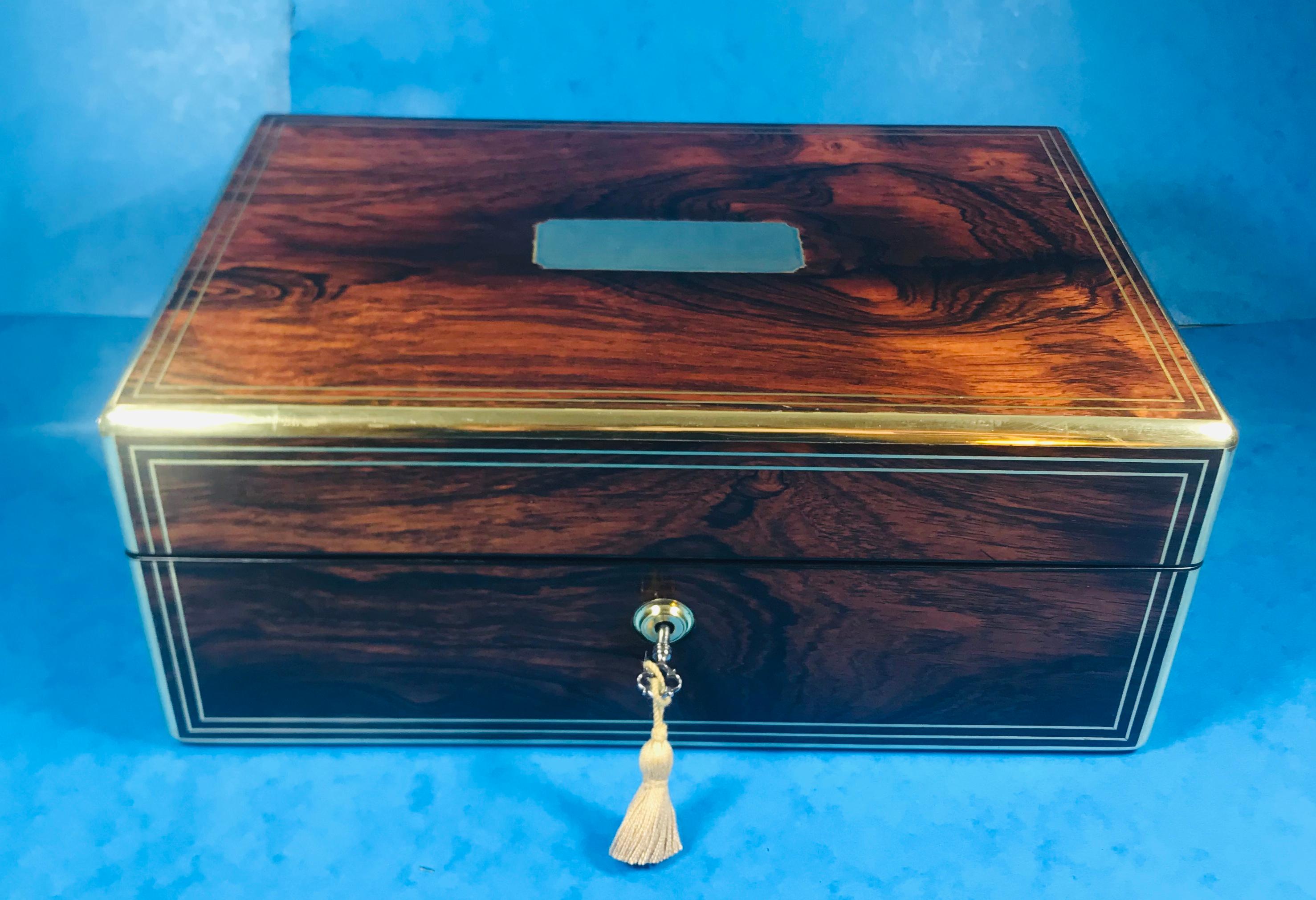 Georgian rosewood jewellery box.
A magnificent rosewood, brass bound and brass inlaid jewellery box, dating back to circa 1820.
The box has brass handles to the sides with rosewood lozenges to the centre.
It would have started life as a