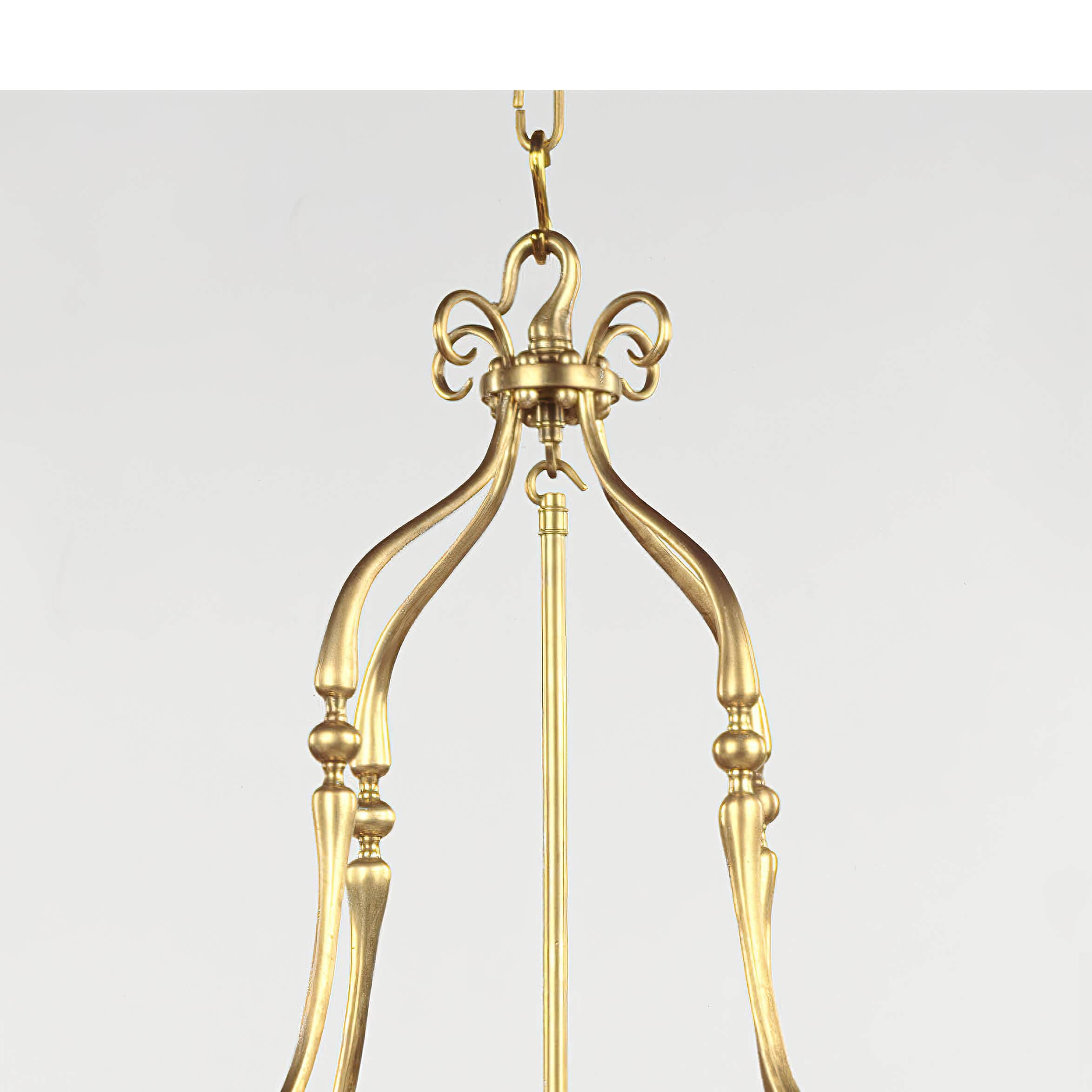 The large English Georgian brass round hall lantern typifies the traditional English style. With the scroll arm supports to the top, above a round frame with egg and dart molded edge and Roman Neo Classic form stop fluted column sides, fitted with