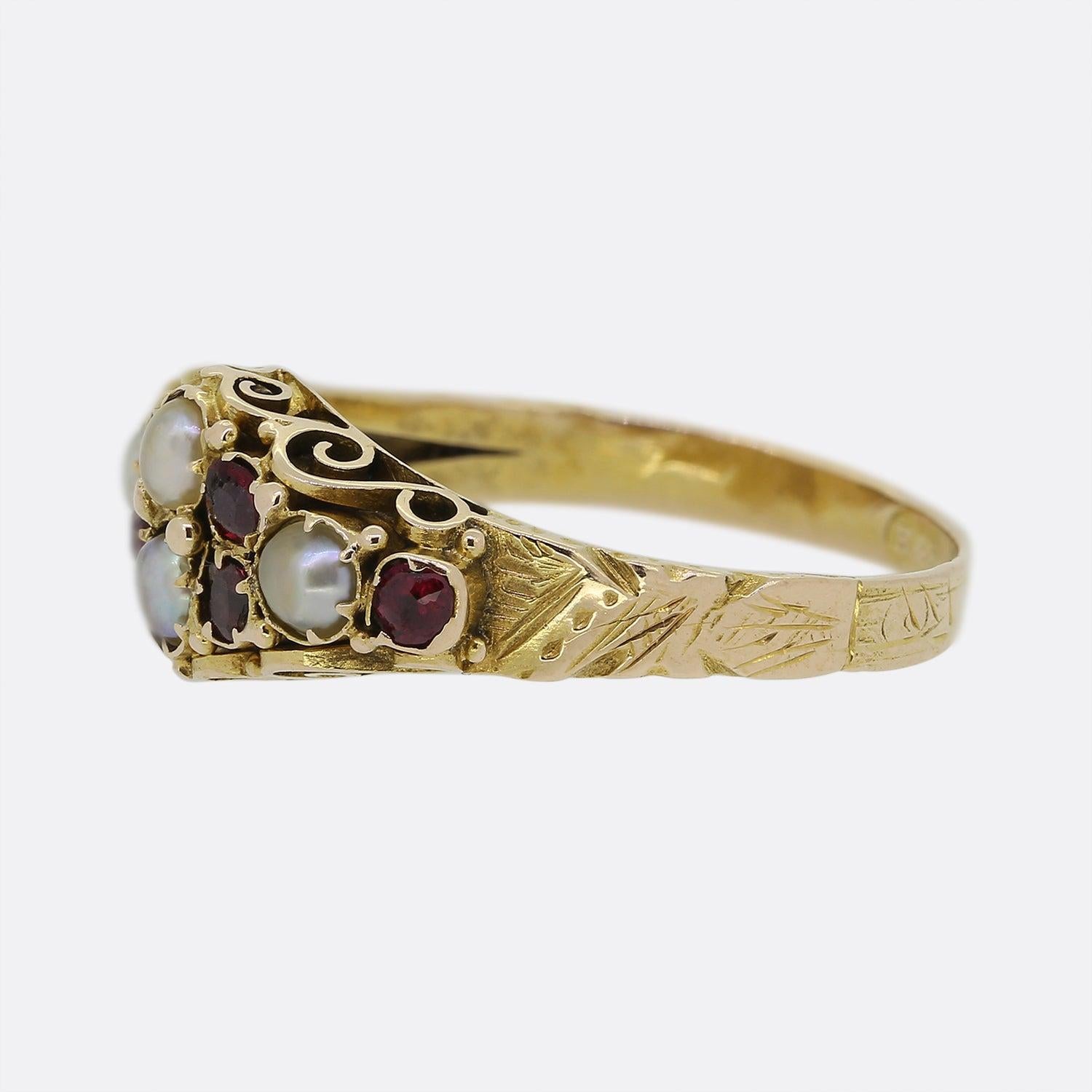 Here we have a 15ct yellow gold ruby and pearl cluster ring from the Georgian era. The face features a charming ensemble of individually claw set round shaped rubies and pearls. The piece is finished with a delightful scrolled under-gallery and a