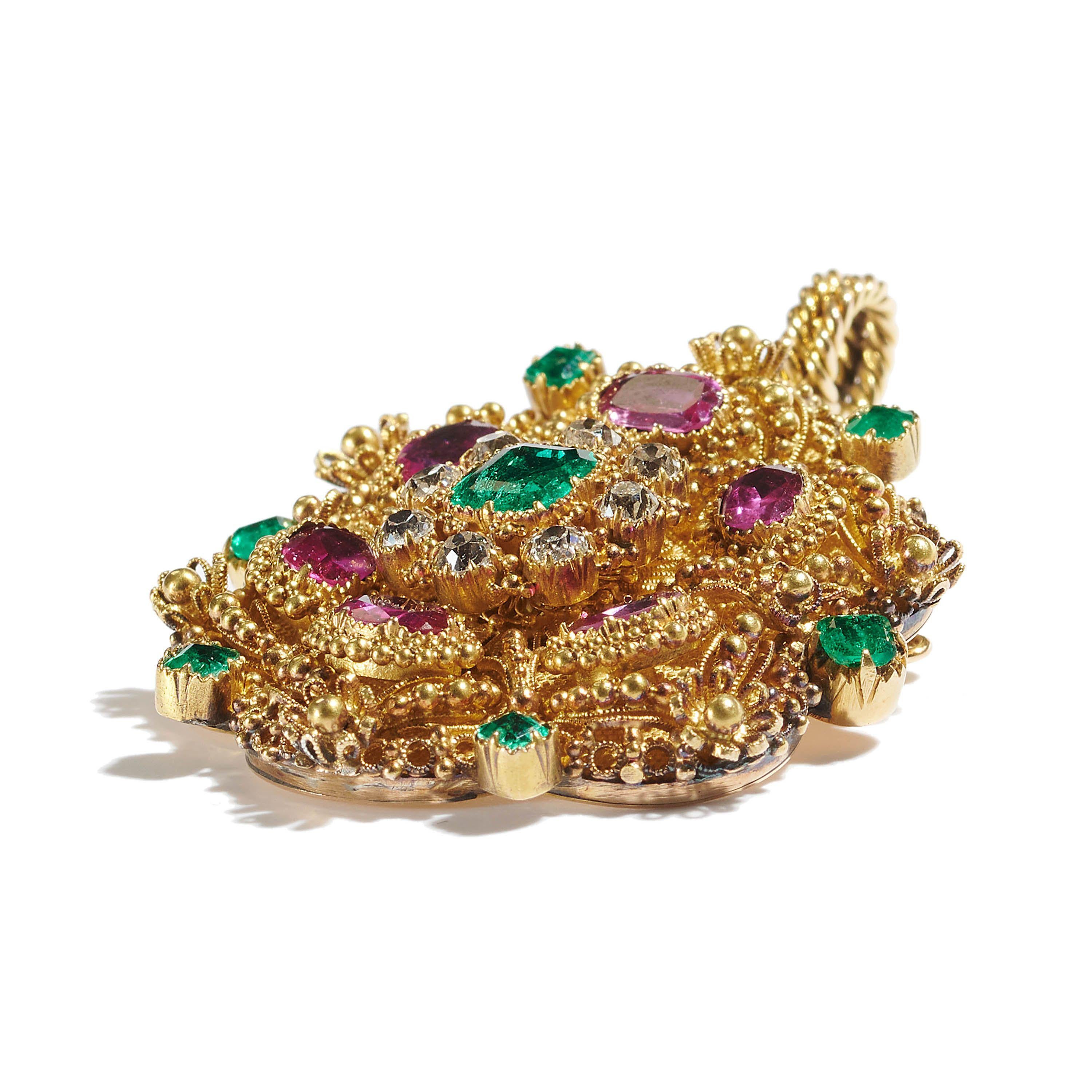 A Georgian cannetille brooch-cum-pendant, with a cushion shaped emerald in the centre, surrounded by a cluster of eight, old mine-cut diamonds, with six, oval faceted rubies and six square emeralds in the surround, with the settings, granulation,