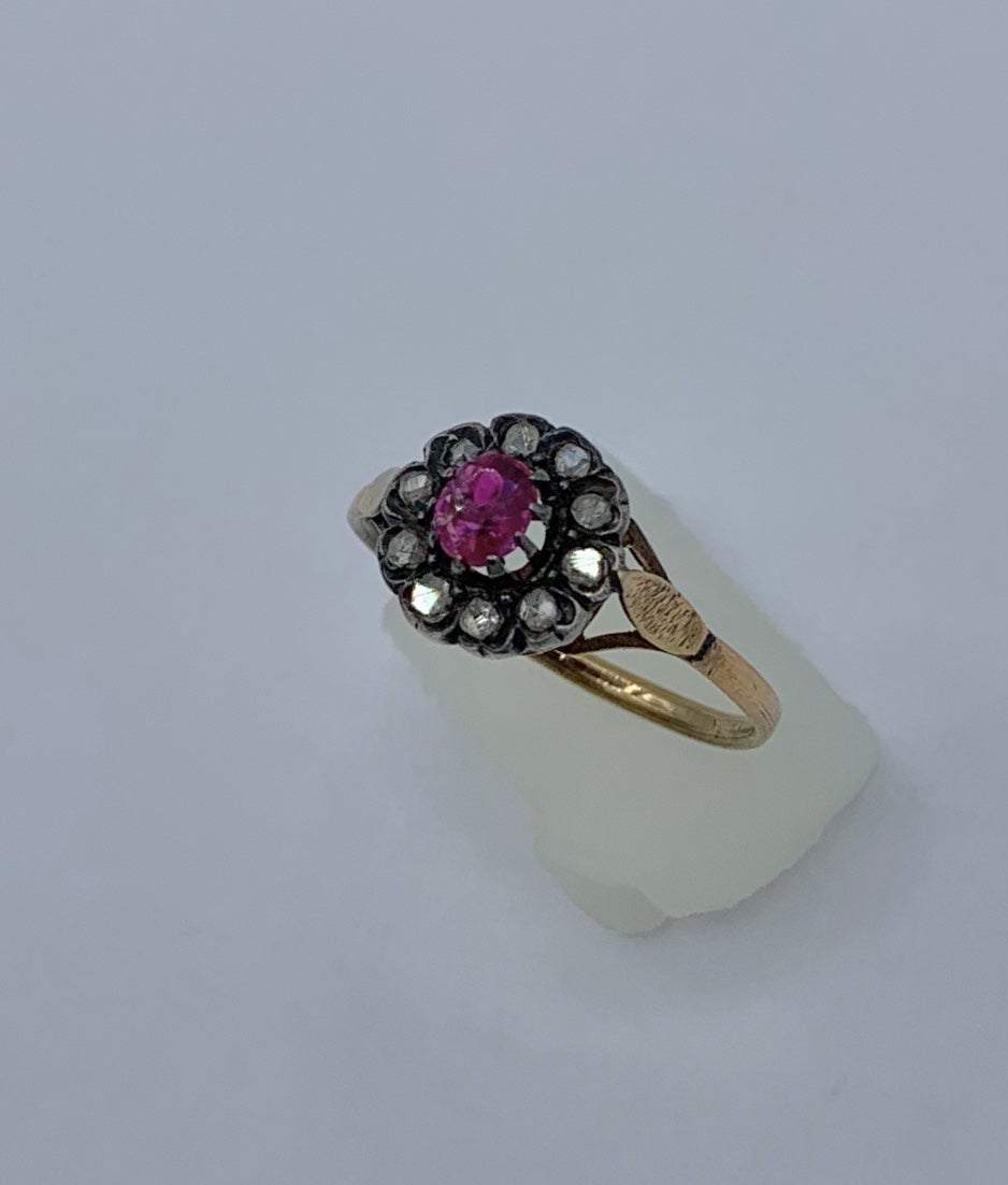 This is an Antique Georgian - Victorian Wedding Engagement Stacking Ring with a gorgeous natural Ruby of stunning beauty surrounded by a halo of 10 sparkling antique Rose Cut Diamonds set in silver atop 18 Karat Gold.   The Ruby is a beautiful round