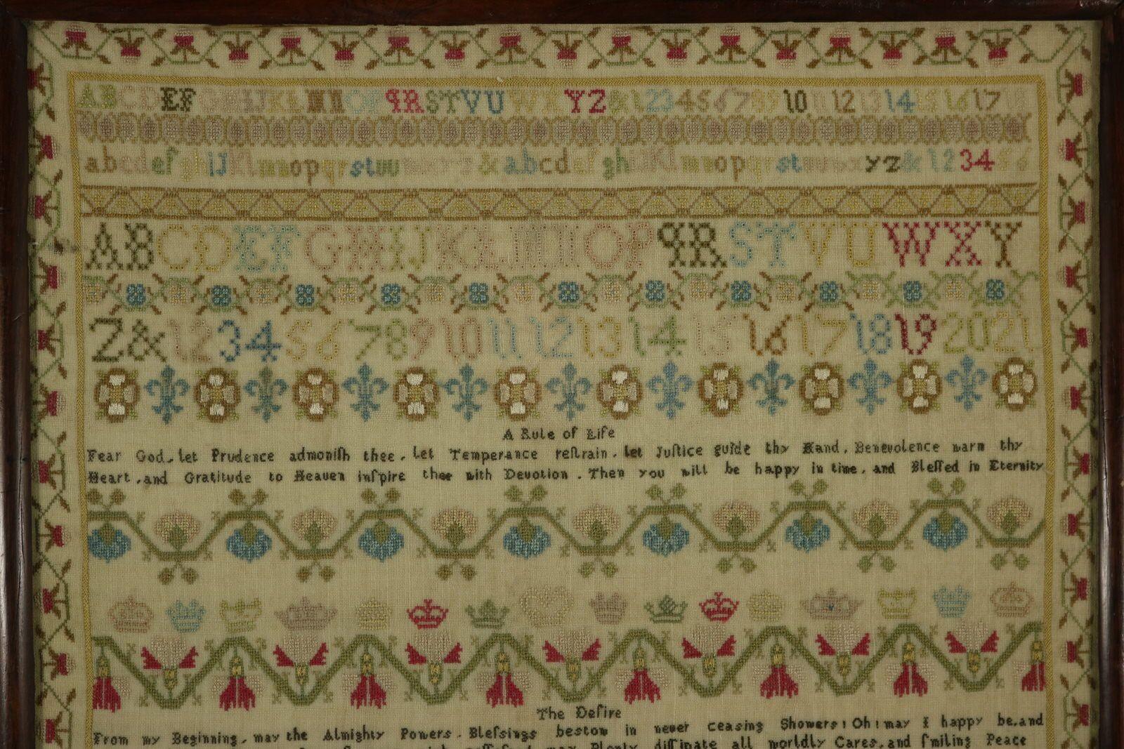 Georgian Sampler, 1815, Ann Smith Aged 9. The sampler is worked in silk threads on a linen ground, in a variety of stitches. Meandering strawberry border. Colours green, blue, red, yellow, copper, silver, pink and brown. Alphabets A-Z in upper case