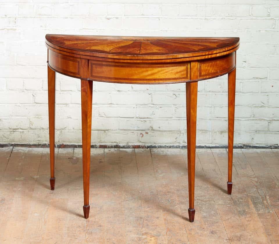 Very Fine George III satinwood card table, the top with unusual swirled fan marquetry and black rosewood banding, purpleheart, sabicu, harewood and penwork inlay, over string inlaid apron and standing on square tapered legs ending in spade feet, the