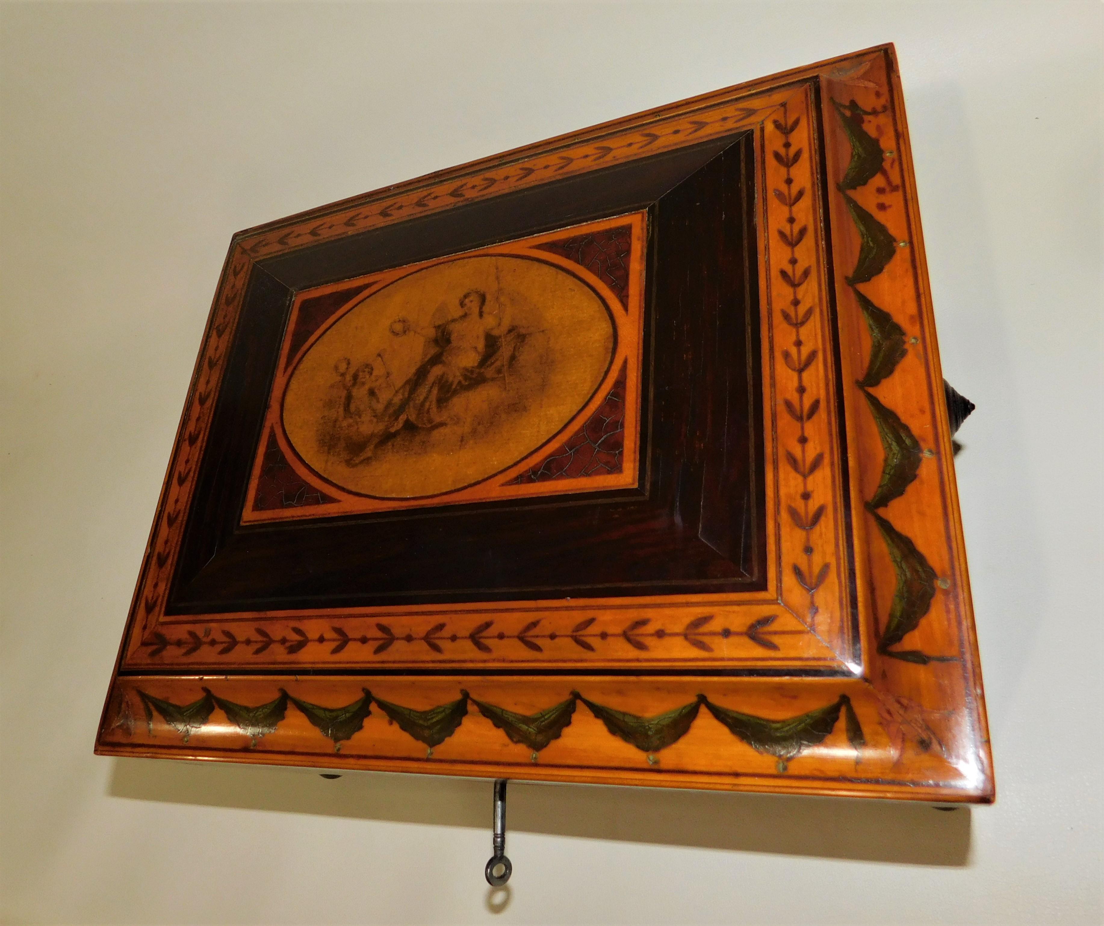 Refitted Georgian satinwood four footed sewing wood box with working lock and key, circa 1825.
