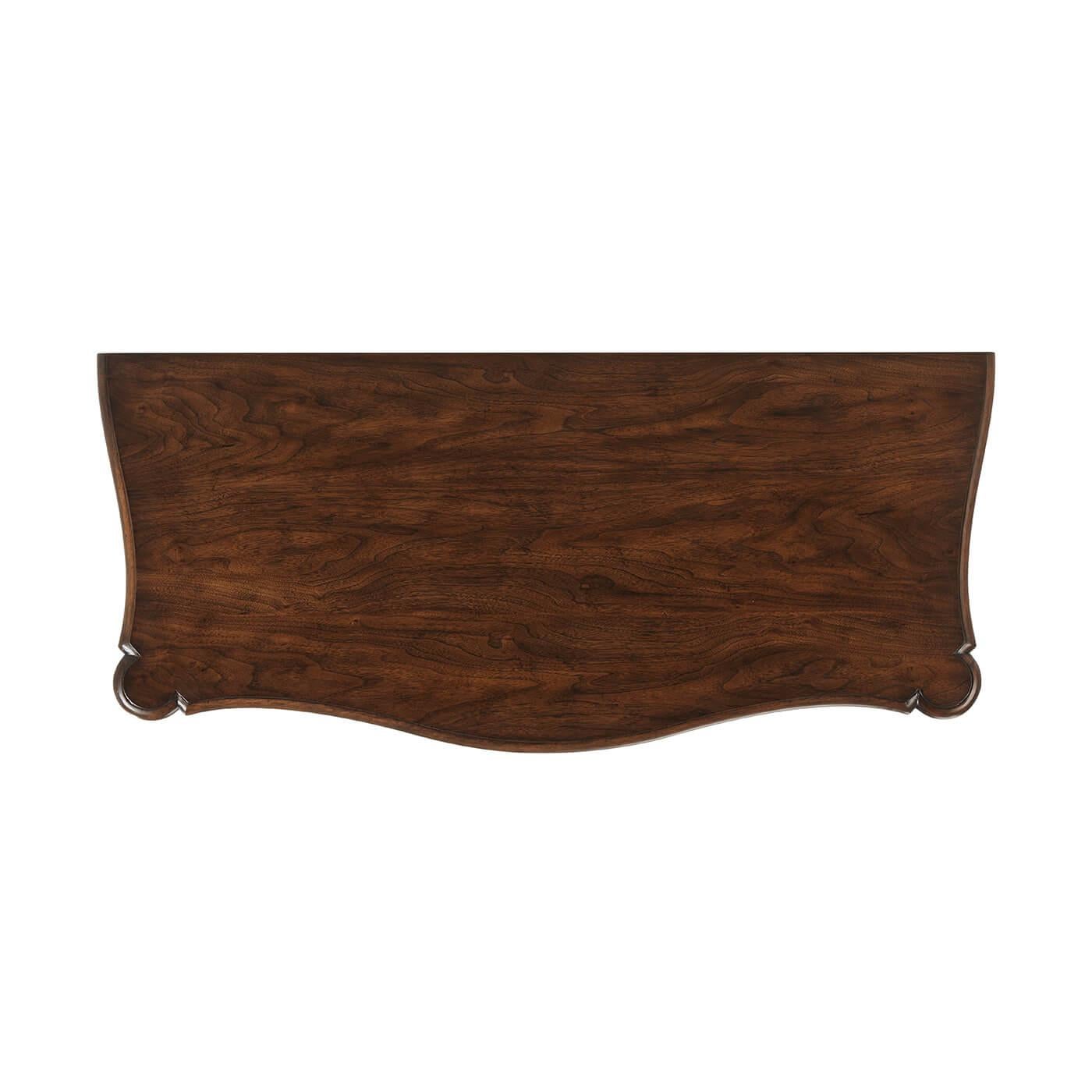 Georgian style serpentine four-drawer chest with a warm walnut finish, a molded serpentine edge top, with four serpentine drawers with drop ring handles, a shaped apron on bracket feet. Variations are expected in the hand-rubbed and distressed