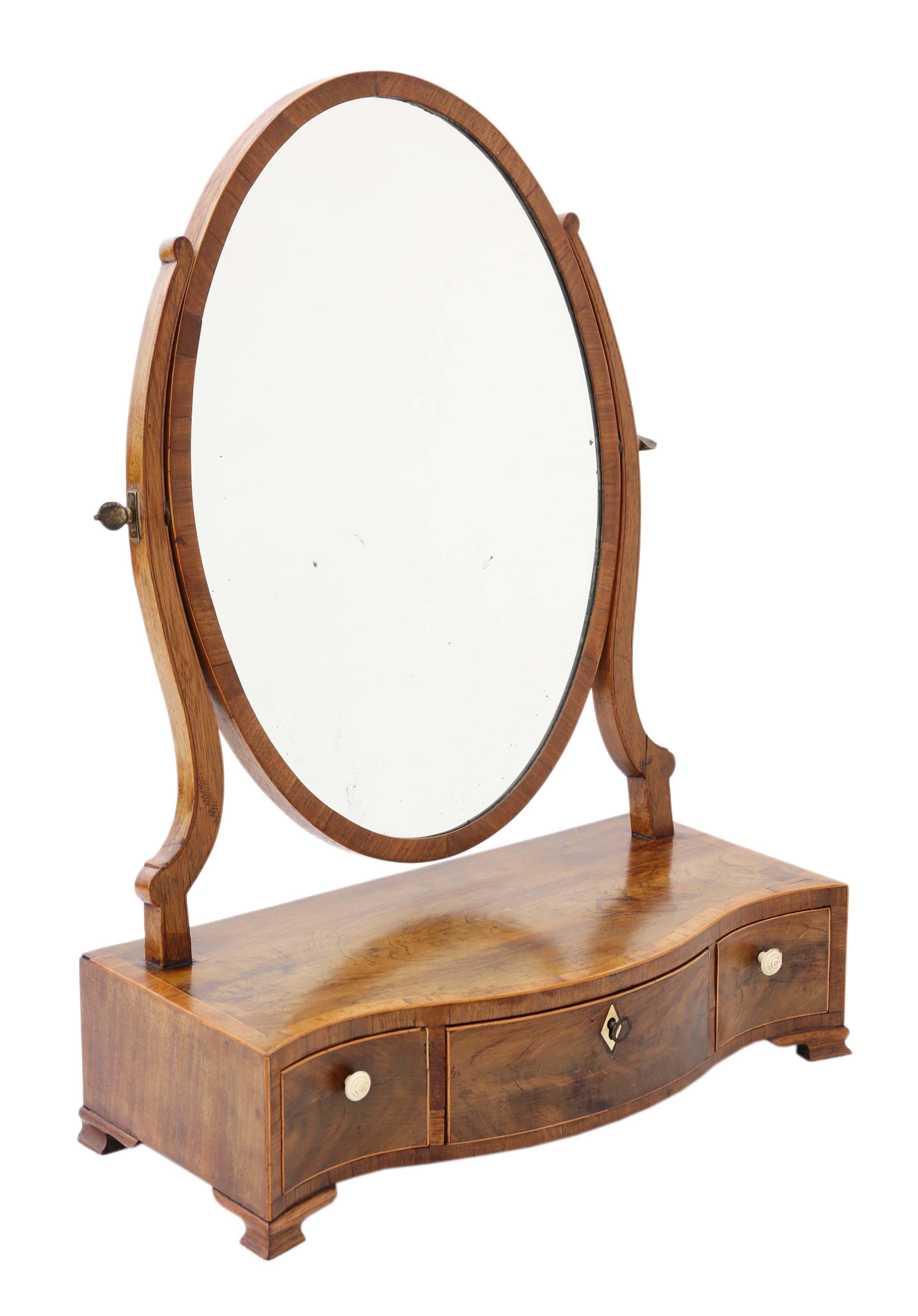 Antique quality Georgian serpentine inlaid mahogany dressing table swing mirror, circa 1800. Attractive crossbanding and line inlays.
This is a lovely mirror that is full of age and charm, with great proportions.
A rare find that would look