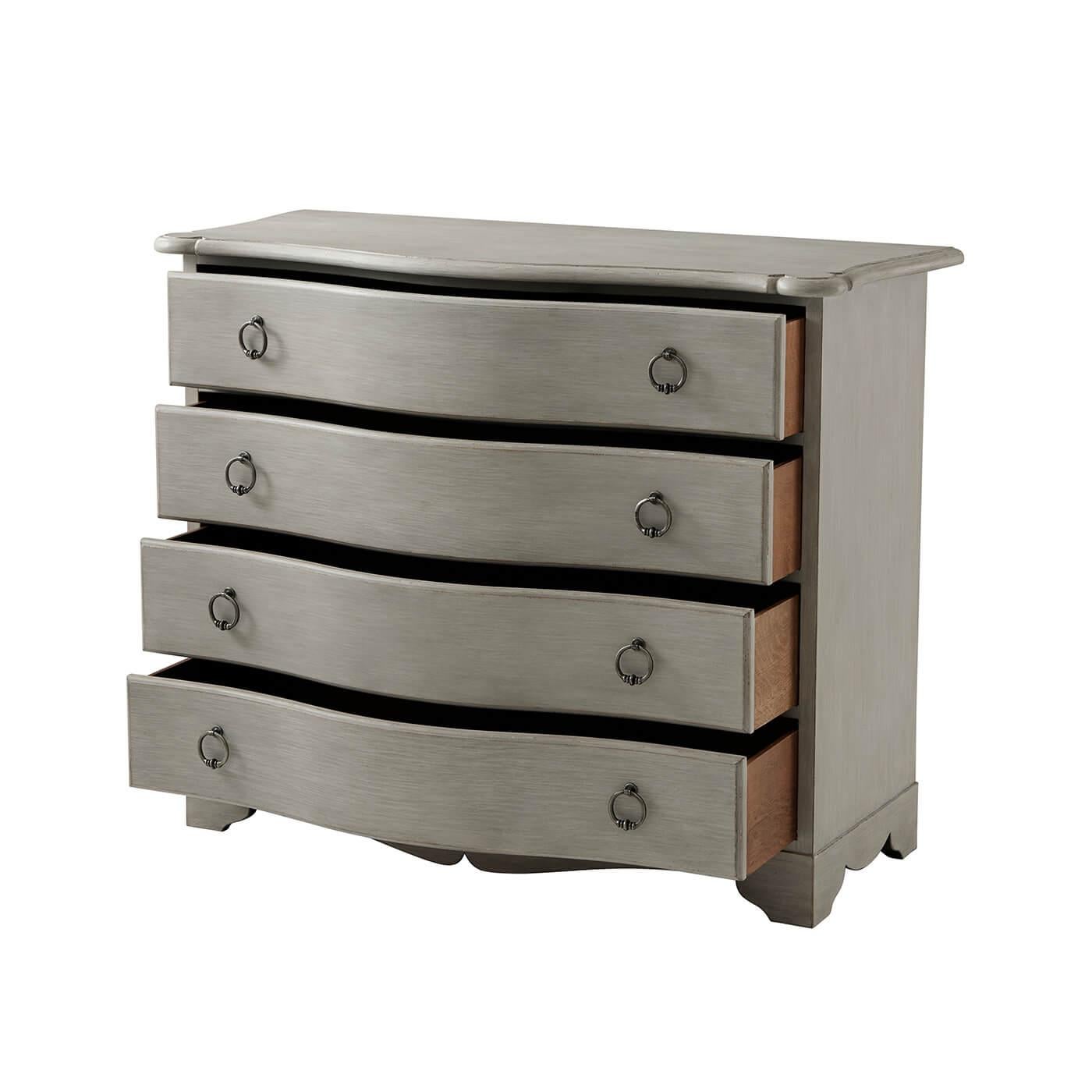 Georgian style serpentine four drawer chest with a warm walnut finish, a molded serpentine edge top, with four serpentine drawers with drop ring handles, a shaped apron on bracket feet. Variations are expected in the hand-rubbed and distressed