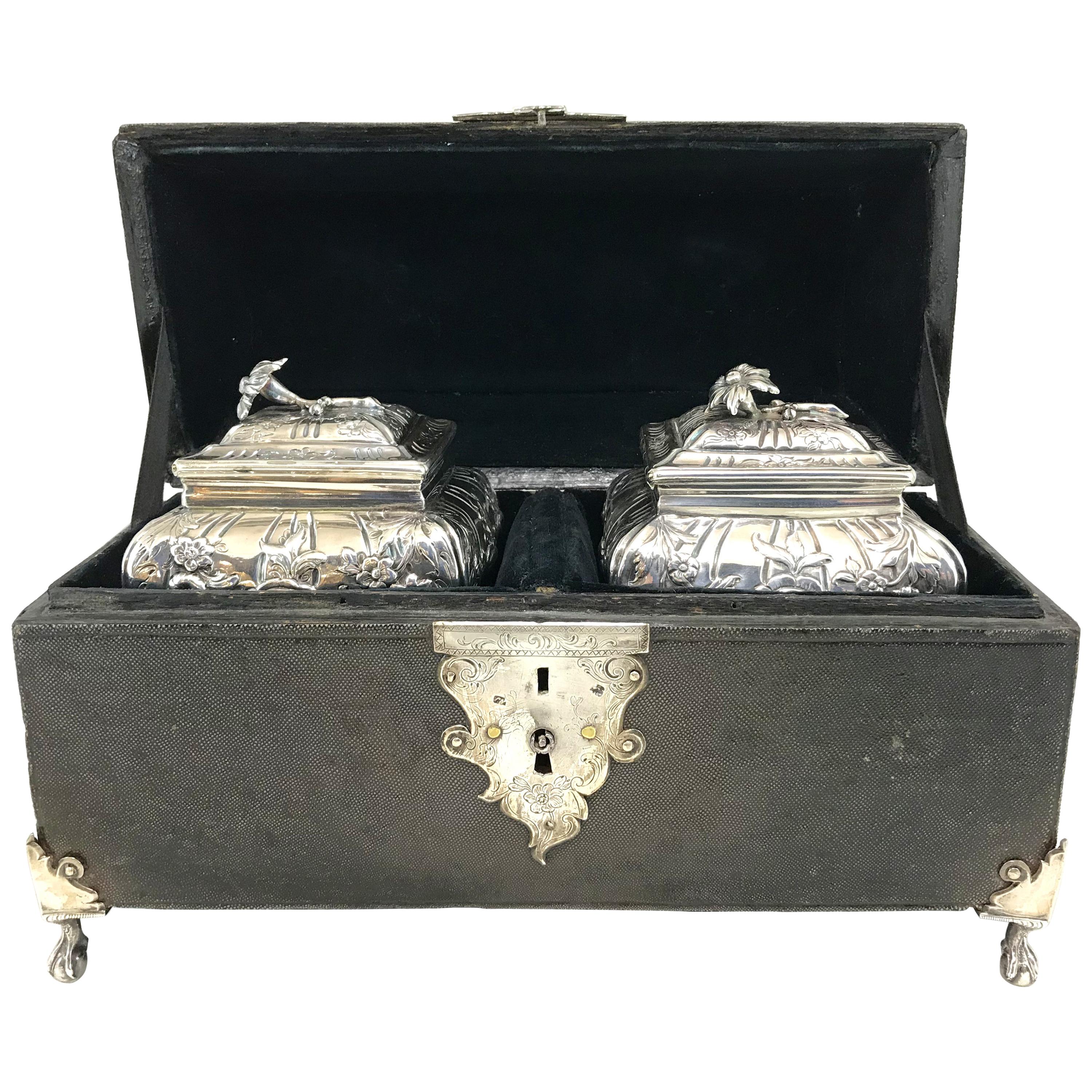 An exceptional George III shagreen cased tea caddy box with silver ball and claw feet, foliate chased silver key hole escutcheon plate, decorative scroll form handleplate and handle with monogrammed cartouche, and a velvet lined fitted interior