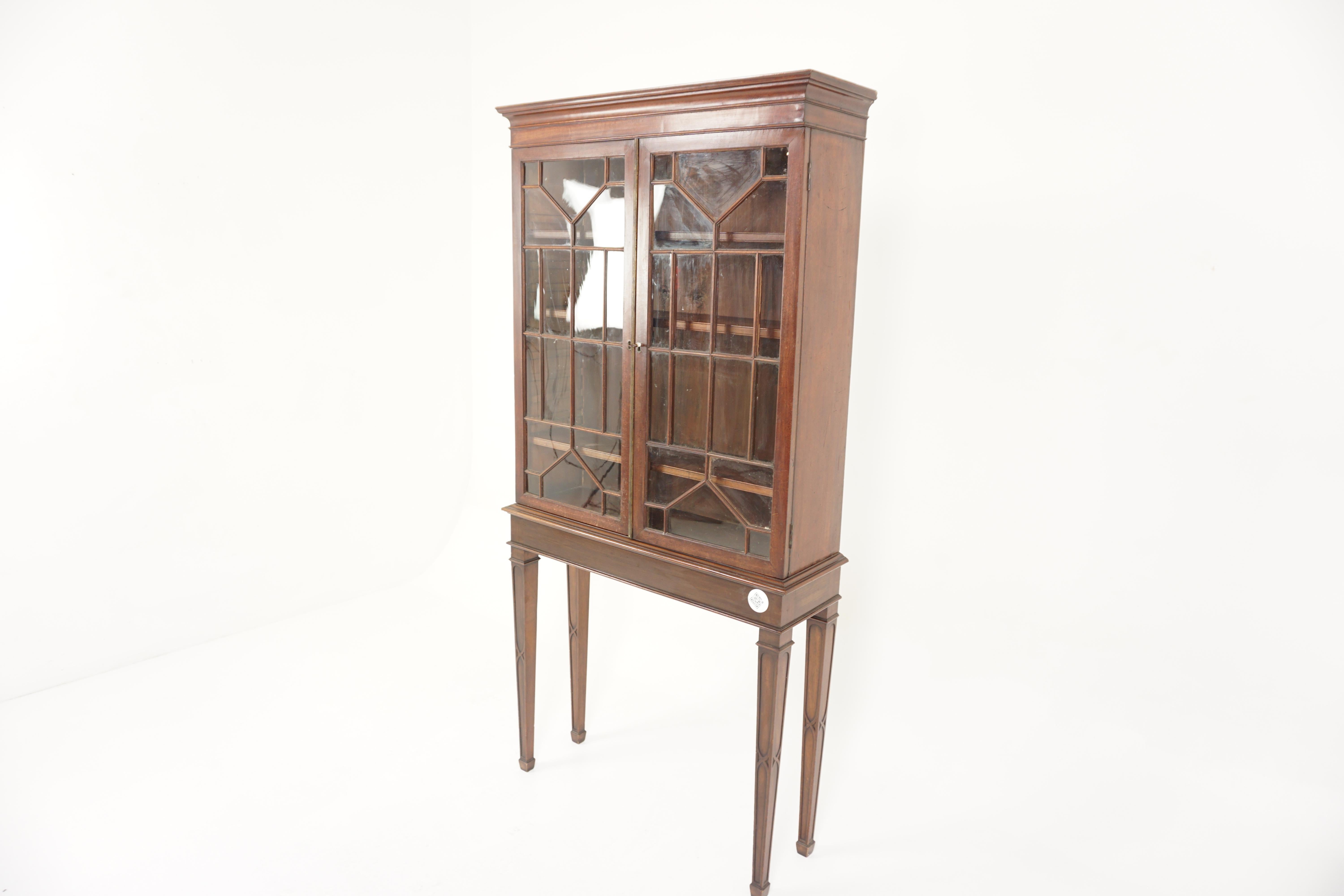 Georgian Sheraton style cabinet on stand, Scotland 1910, H823

Scotland 1910
Solid walnut
Original finish
Rectangular moulded top
Original glass doors with geometric moulding to the front
Opens to reveal 3 slide out shelves
Original working