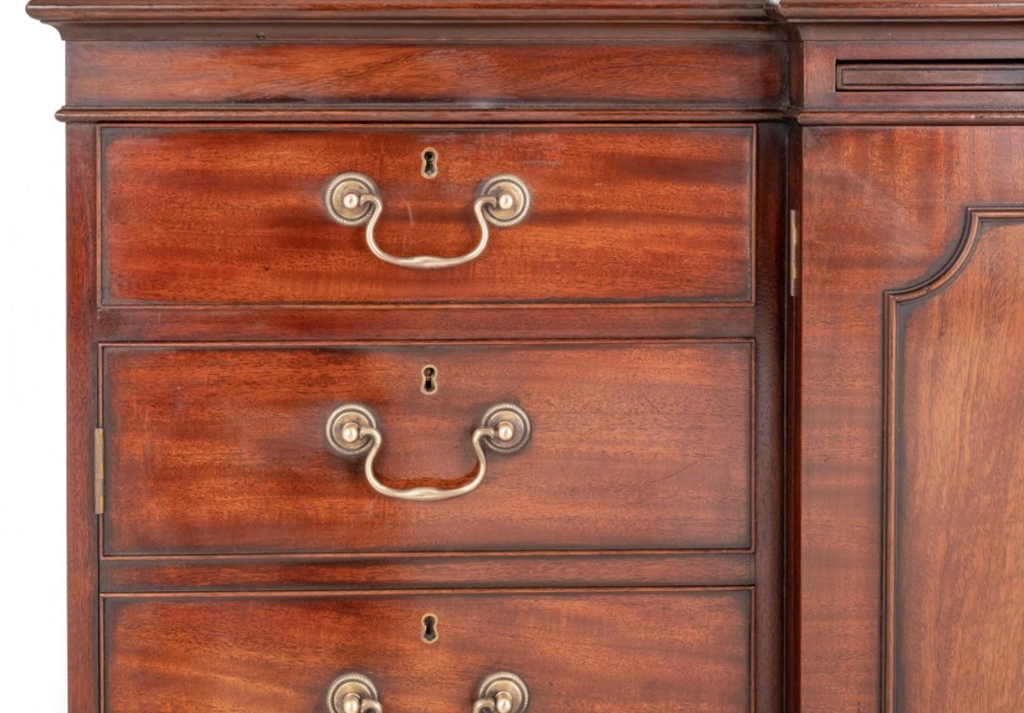 Georgian Revival mahogany breakfront sideboard.
This quality sideboard stands upon shaped bracket feet.
Circa 1920
The sideboard features panelled doors to the centre flanked by faux drawers, 2 working oak lined drawers and a pullout slide.
The