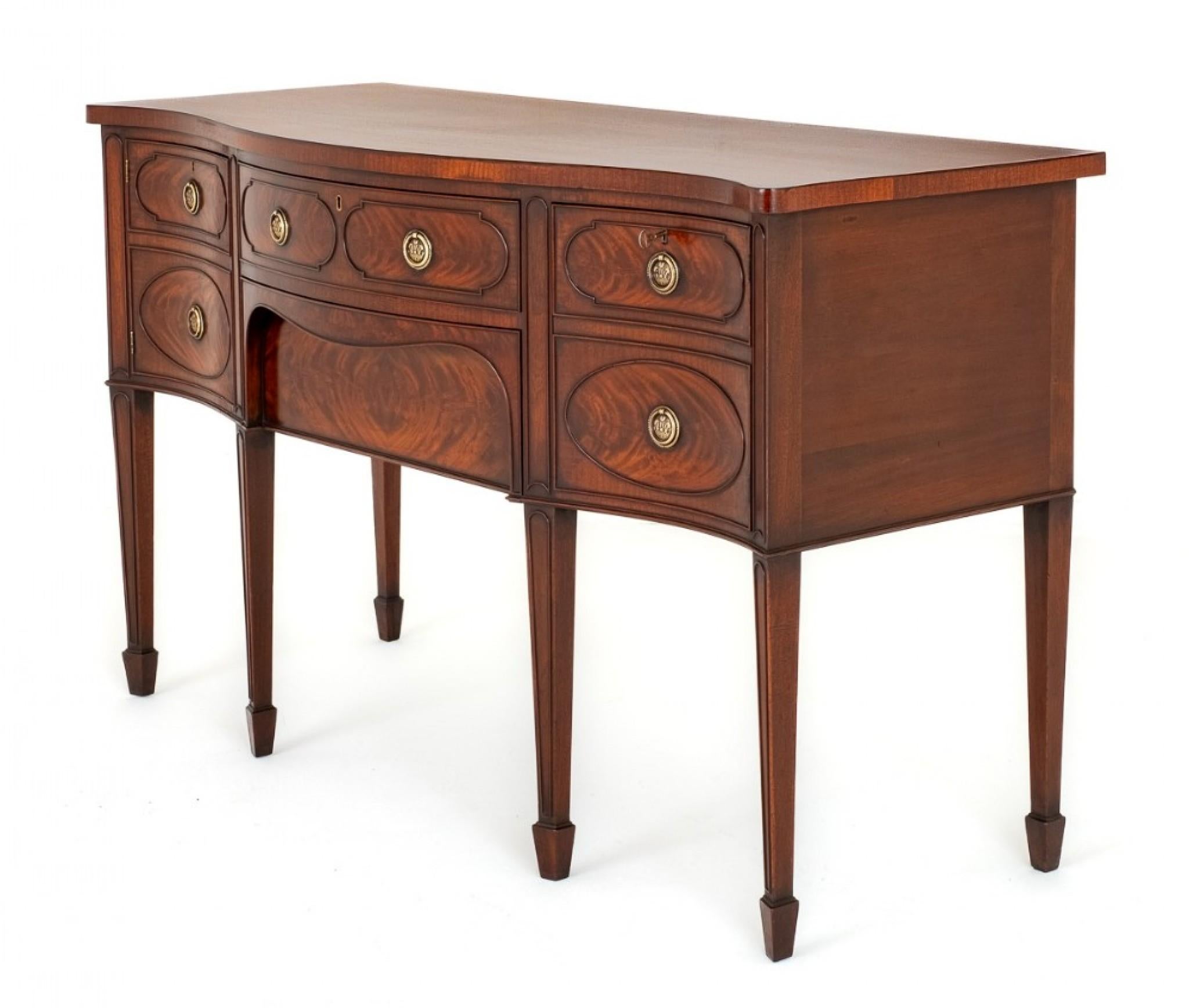 This Quality Sideboard is of a Serpentine Form.
Having an Arrangement of 2 Oak Lined Drawers and 2 Cupboards.
Circa 1800
The Drawers and Cupboard Fronts Feature Wonderful Matched Flame Mahogany Veneers and Applied Moldings and Retain Their