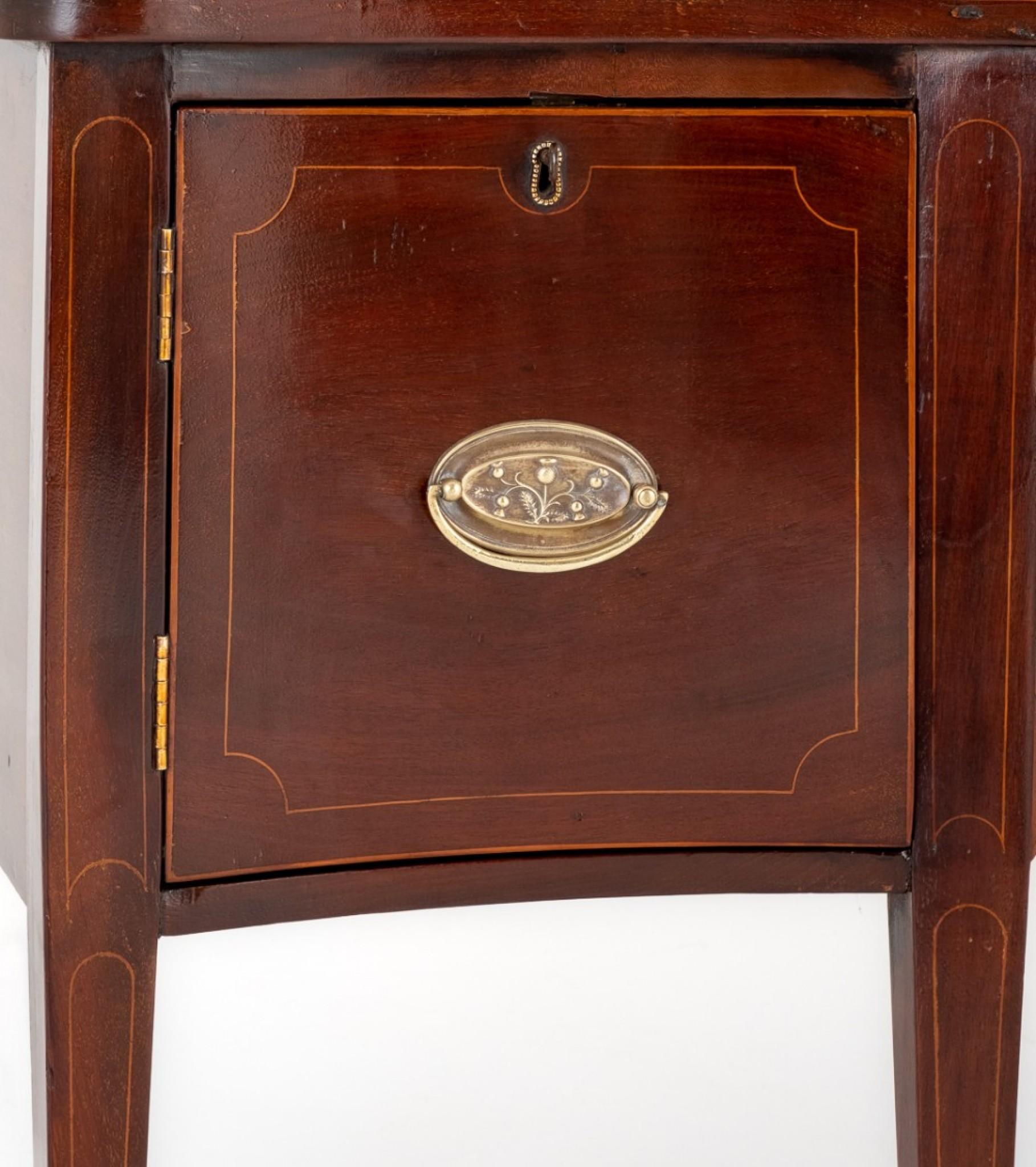 Here We Have a Georgian Revival Mahogany Sideboard of Small Proportions.
Standing Upon Tapered legs With Spade Feet.
Circa 1900
Featuring a Central Drawer Flanked By Cupboards.
The Drawer and Door Fronts Having Boxwood Line Inlays and Oval Embossed