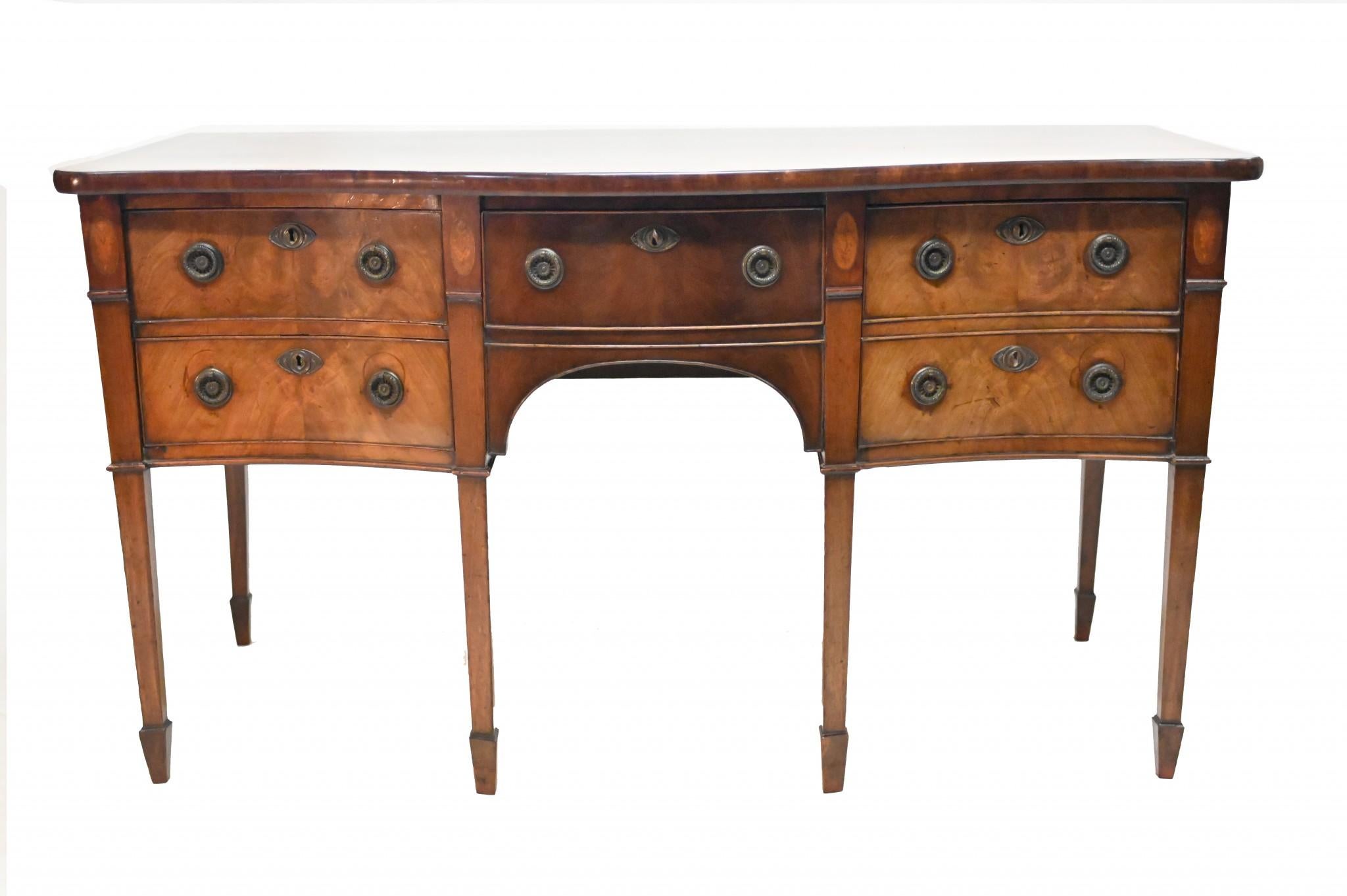 Refined Georgian sideboard in mahogany of serpentine form
Original handles with inlaid patera beside drawers
Circa 1810
Classically refined design with five drawers so ample storage
Classic piece of English antique furniture Viewings available by