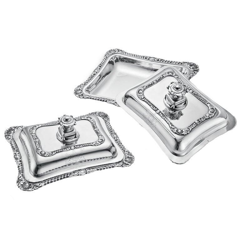 A pair of heavy, Georgian covered vegetable dishes in sterling silver, made in 1823, with marks for London and 'IH' in square reserve. The handles can be removed, so that the tops may be used as serving dishes as well.

The dishes use earls'