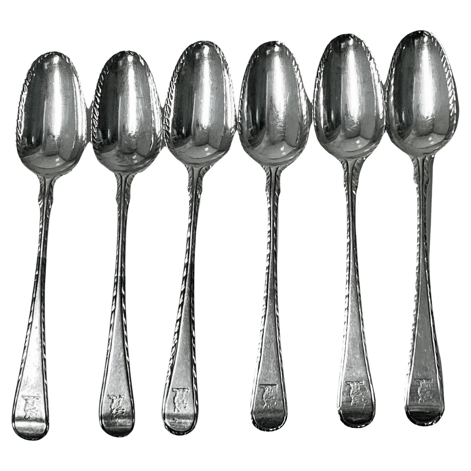 Georgian silver feather edge set of 6 teaspoons London circa 1770 Philip Roker. Each engraved with crest. Bowl edges also feather edge. Some marks stretched. Length: 5 inches. Weight: 86.49 grams.