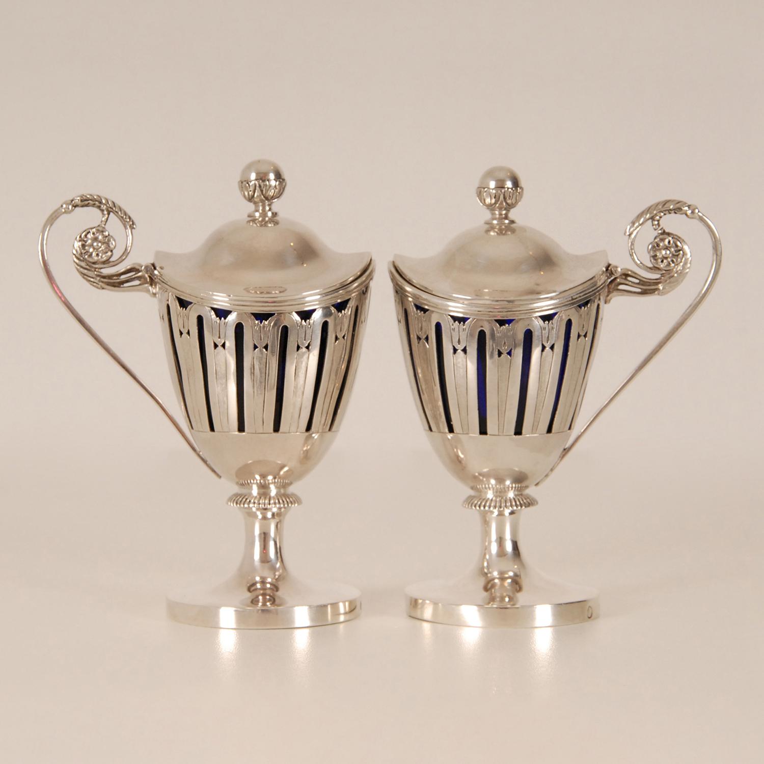 Museal Antique Georgian Sterling Silver Mustard pots
Style: Empire, Georgian, Antique, Regency, Napoleonic
Material sterling Silver with cobalt blue glass liners
Fully hand made openwork body with husk pattern.
The silver is not cast but completely