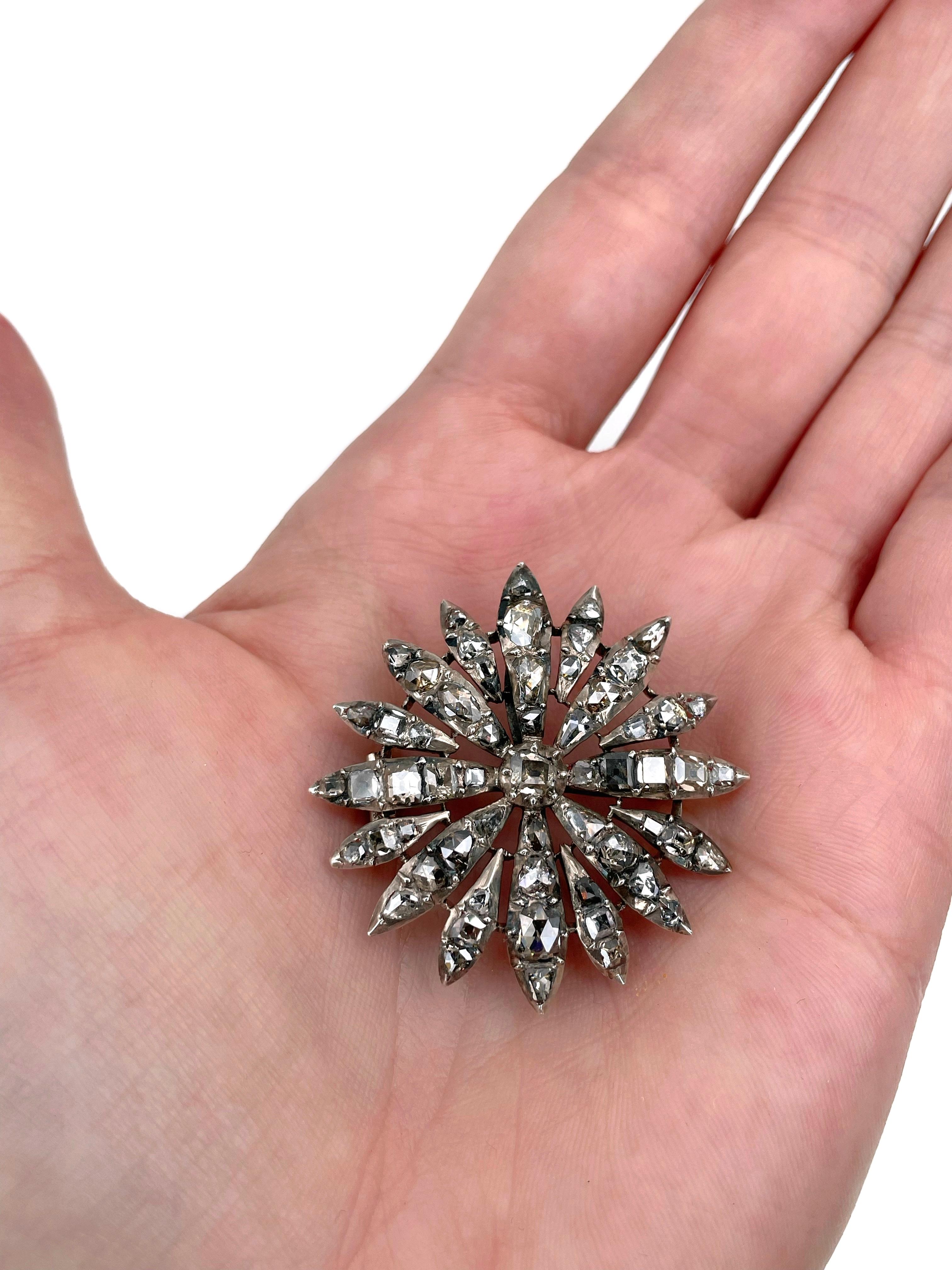 This is a stunning Georgian era starburst brooch-pendant crafted in silver. It features rose cut and table cut diamonds that in total weight ~5ct. 

The piece showcases exquisite craftsmanship from the late 18th to early 19th century. The gems are