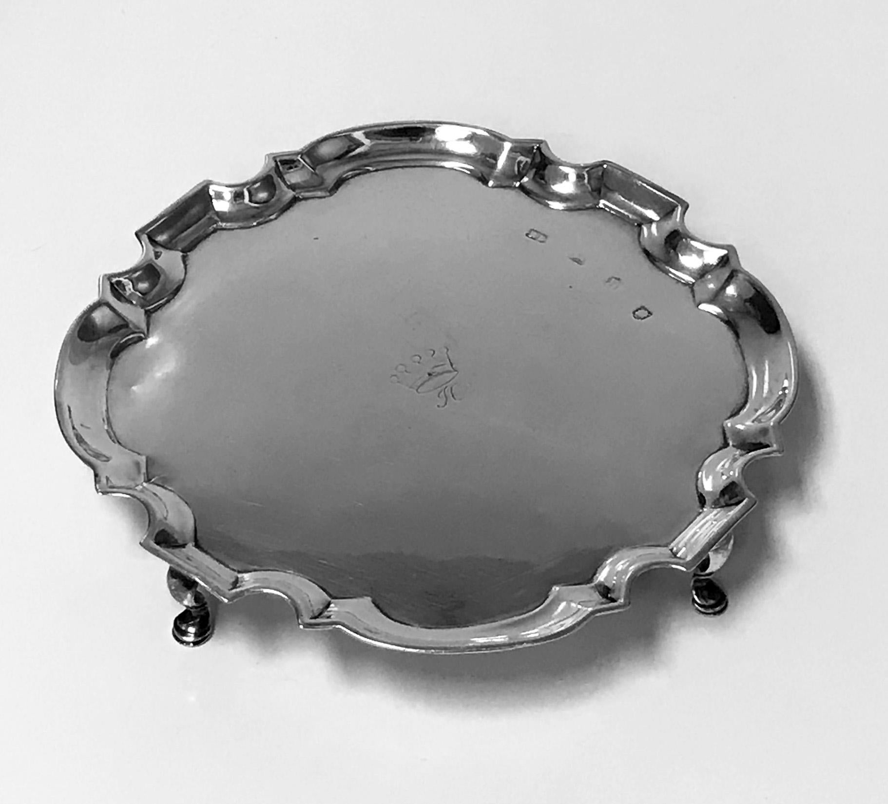 Georgian silver salver London, 1732, Richard Burcombe. The salver of shaped cushion round form on four turned feet, engraved in the centre with a coronet and H in script beneath. Measures: 7.50 inches wide. 8.75 oz. (272.2 grams).