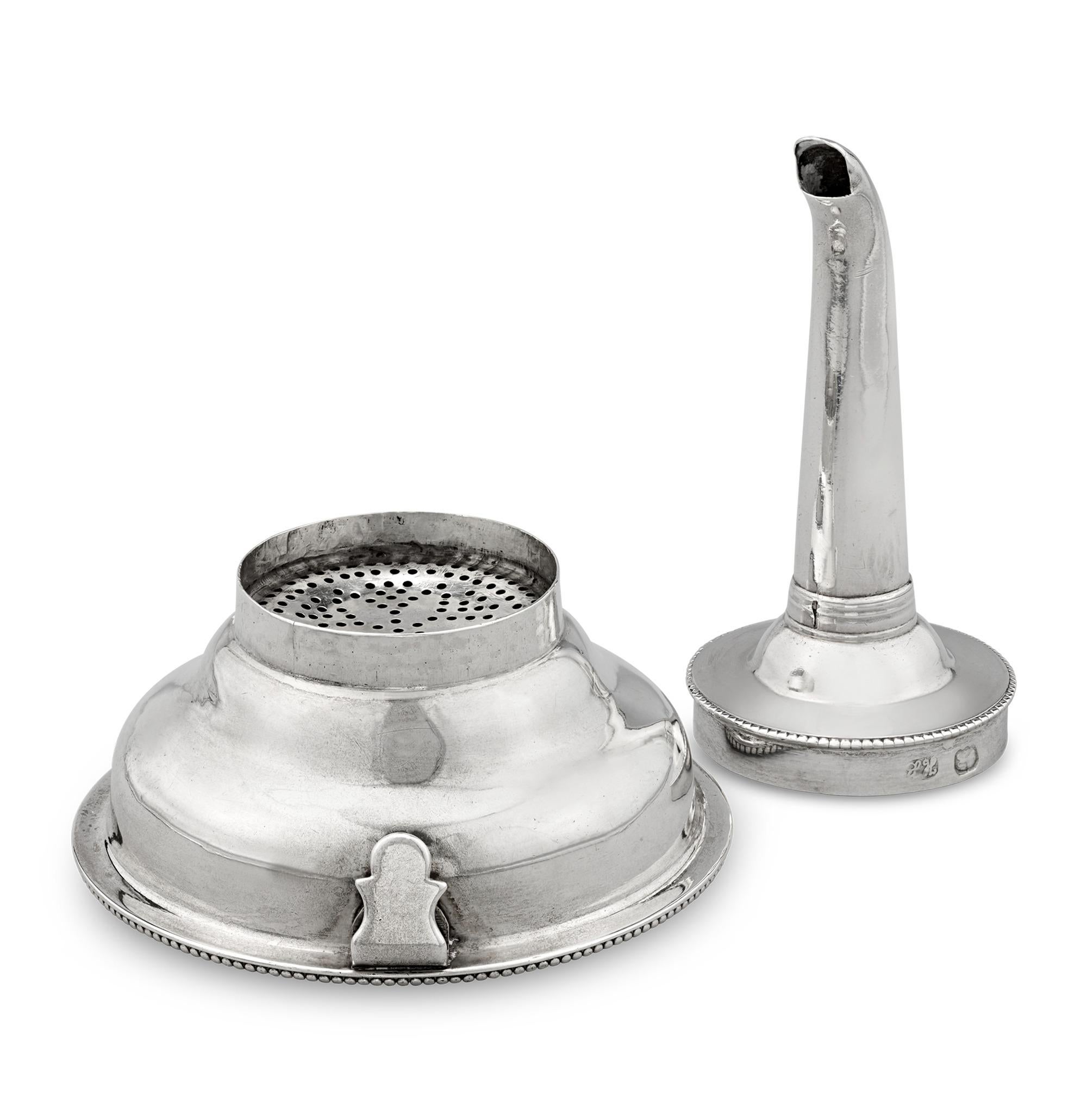 Silver Wine Funnel
Hester Bateman
Hallmarked London, 1784

Featuring her signature beaded edging and refined style, this George III silver wine funnel was crafted by the “Queen of the Silversmiths,” Hester Bateman. The funnel fastens to the rim of a